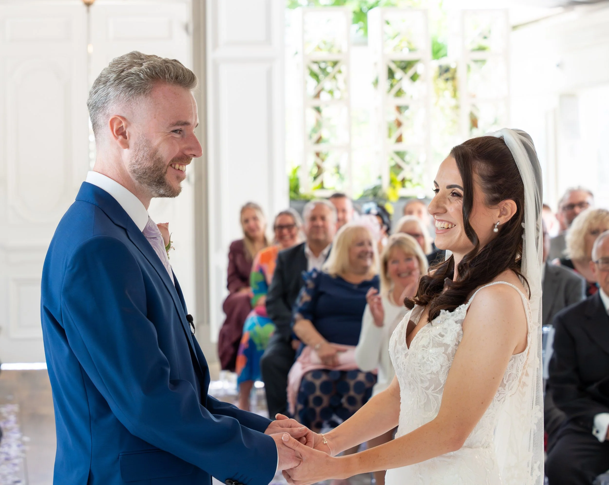 Bride and Groom at the ceremony smiling -  Friern Manor wedding