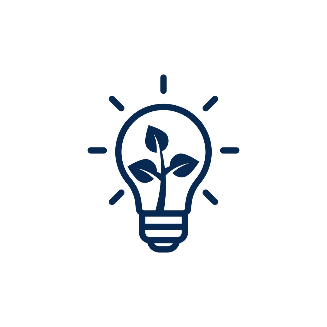 A light bulb that is lit up has a plant growing inside of it.