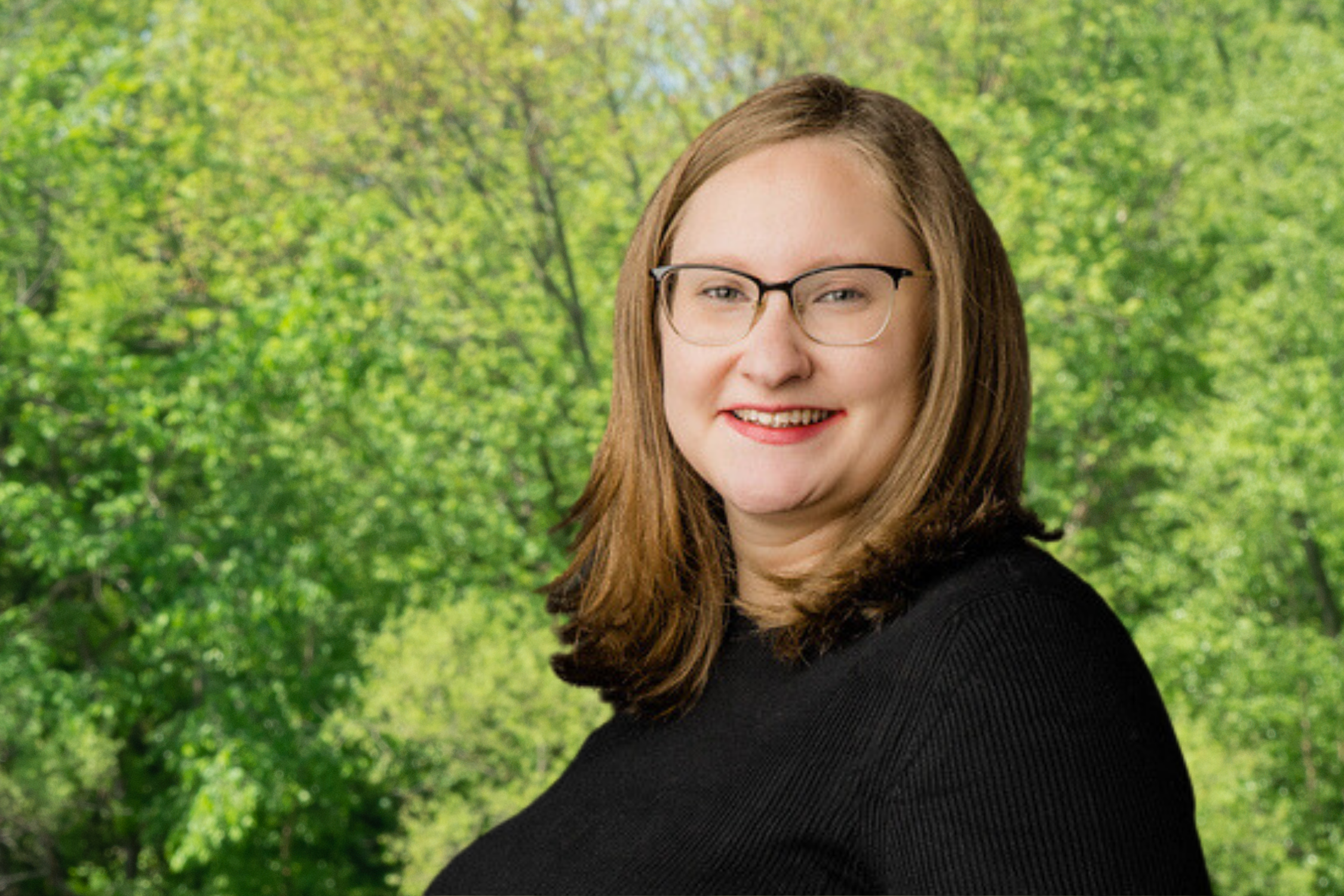 An head shot of Cara Vought in front of trees.