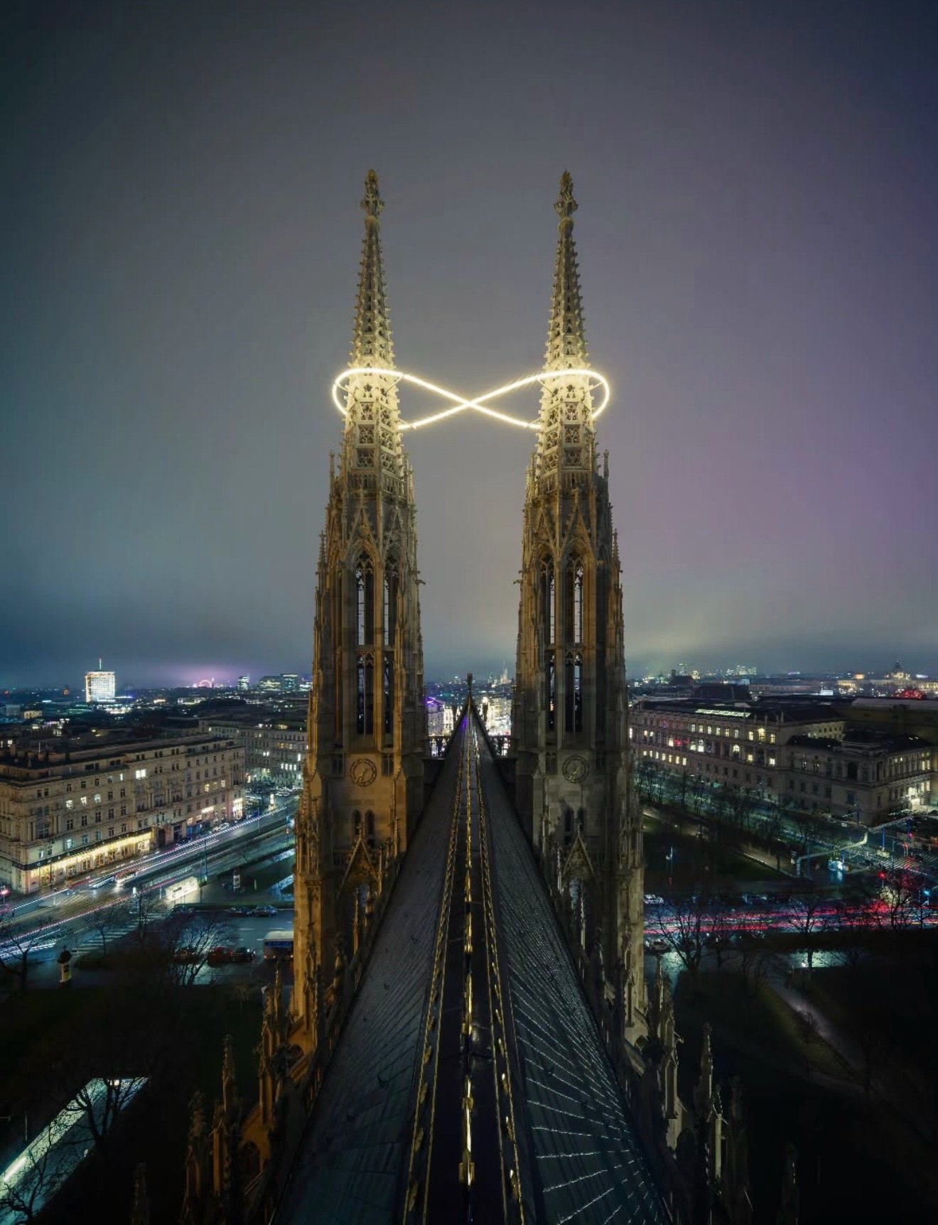 🔺TRIADIC LOVES🔺

Infinity, suspended between spires.
@billithanner glowing loop turns Vienna&rsquo;s neo-Gothic skyline into a moment of pure wonder&mdash;where architecture, light, and imagination meet somewhere between earth and sky. ♾️