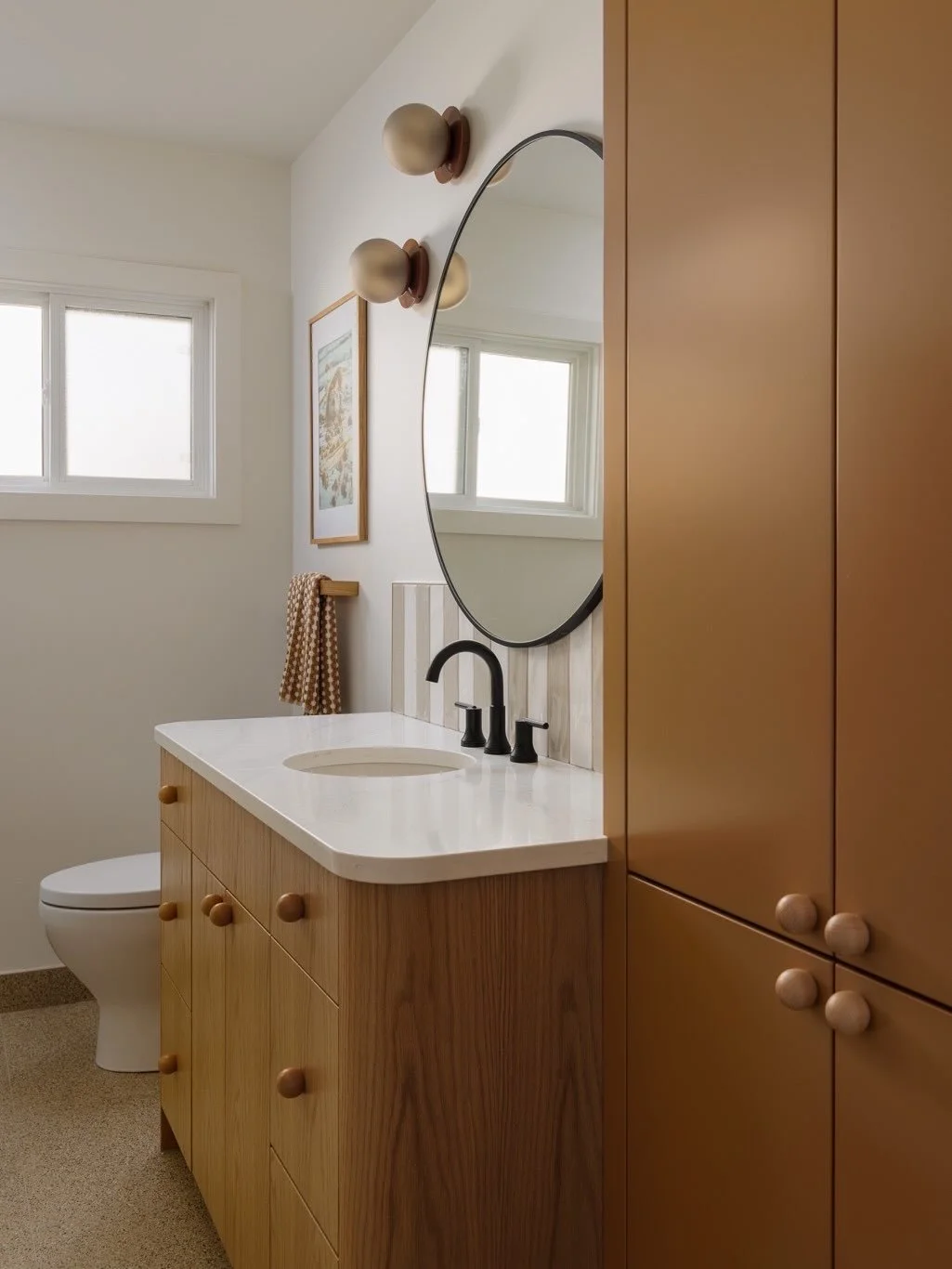From cold + drab to warm + welcoming: the perfect little main bathroom redo at our #SFWildwoodReno project. 
Our favourite detail? The finish-swapped ball knobs on the orange cabinet + wood vanity 💕

📸: @klassen_photography 
🛠️: @feegradecontracti