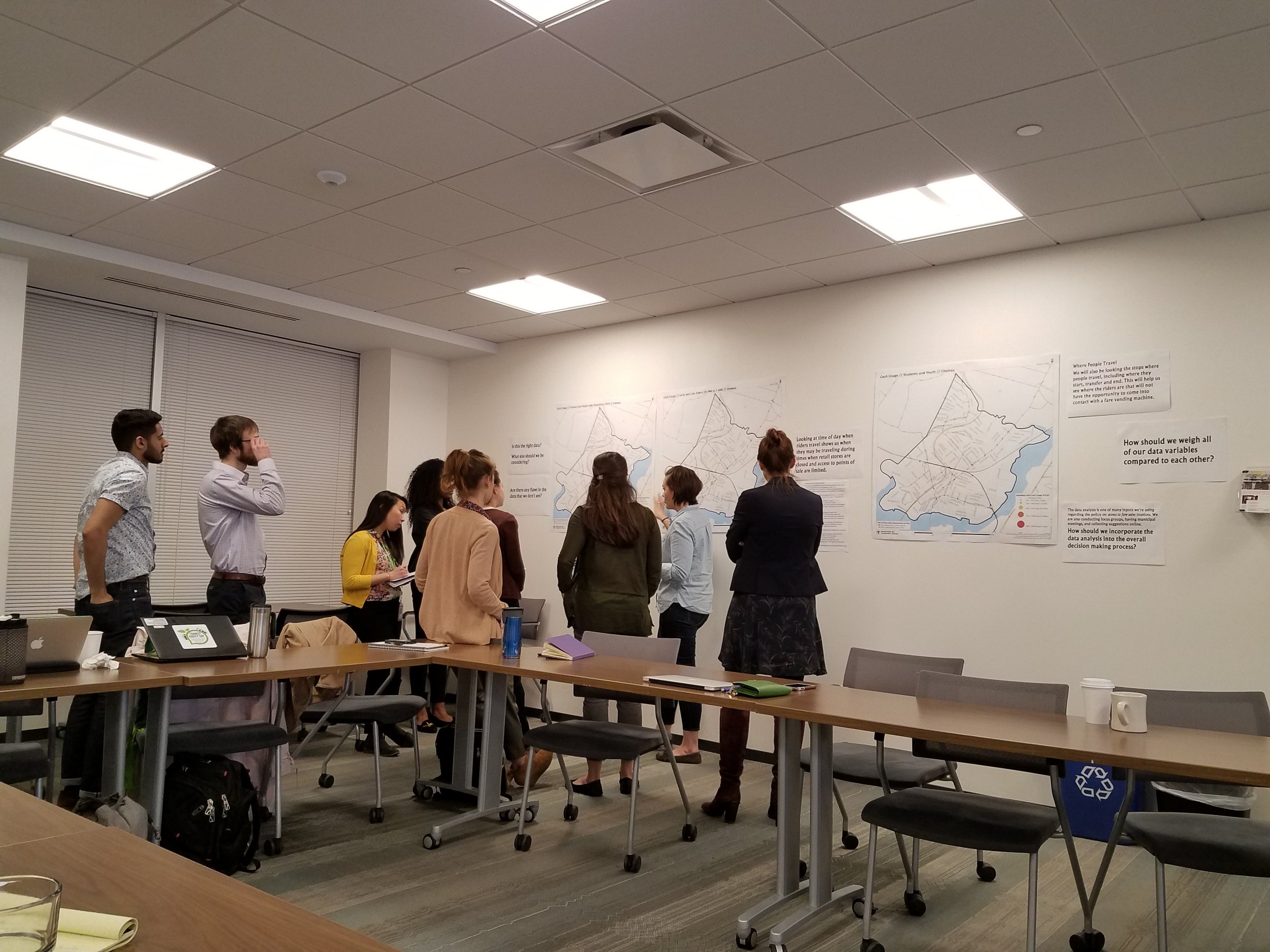 A group of advocates on the “Data Gallery Walk” ask questions of MBTA representatives and share new ideas for the data analysis process.