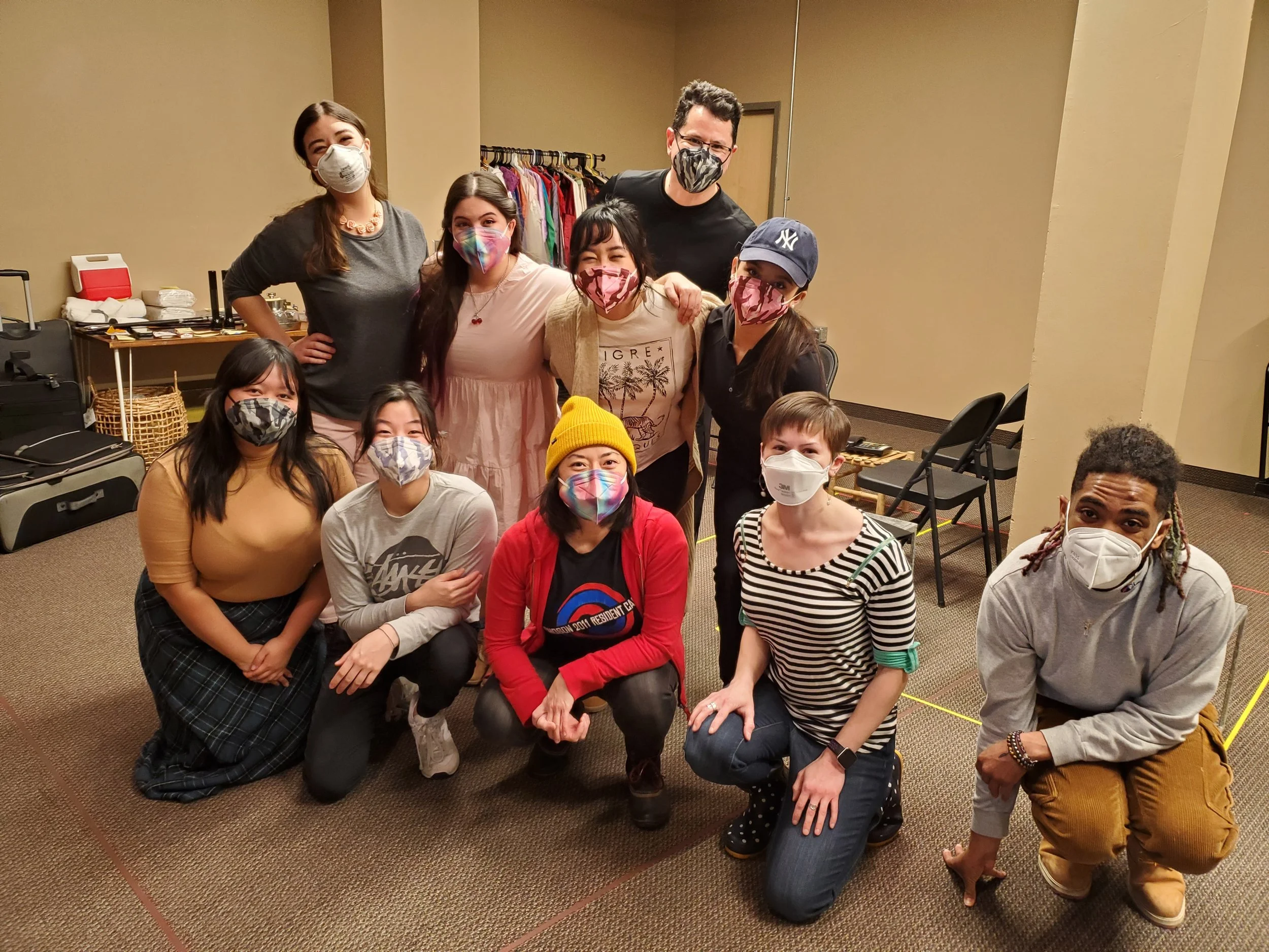 Some cast and production crew of MAN OF GOD, all wearing masks and posing during rehearsal.