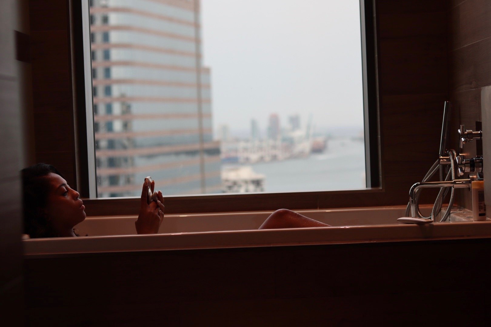 Girl in Bathtub with City View