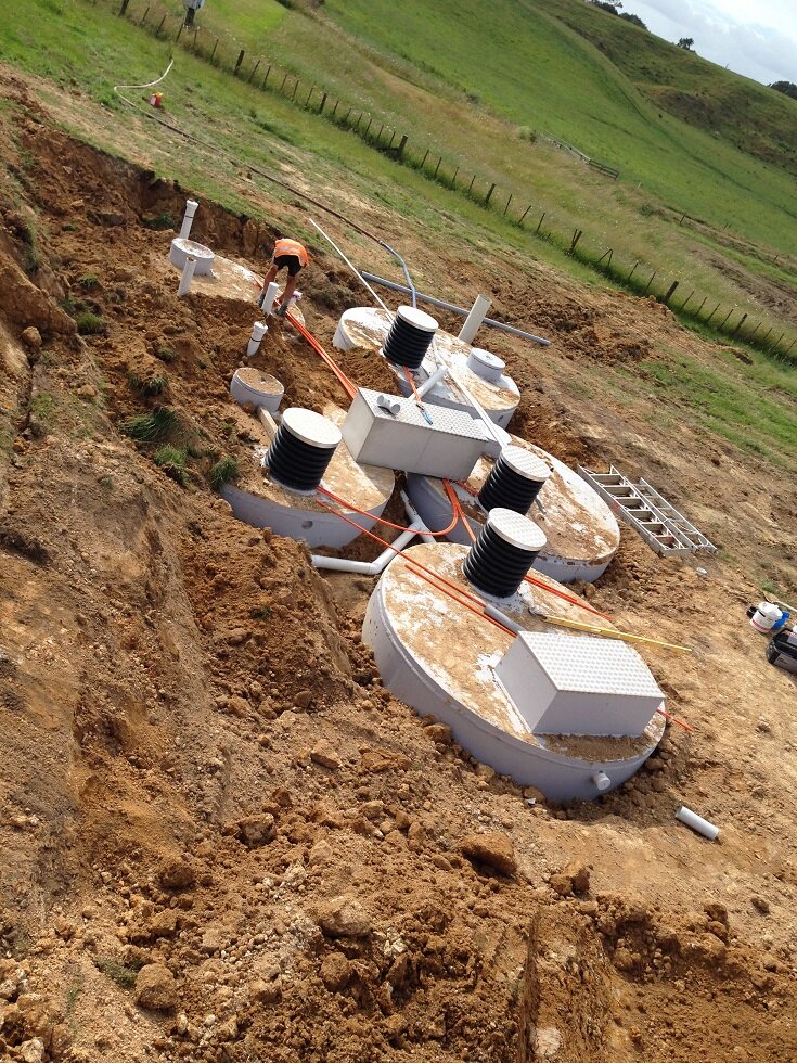 five tanks in ground half covered.jpeg