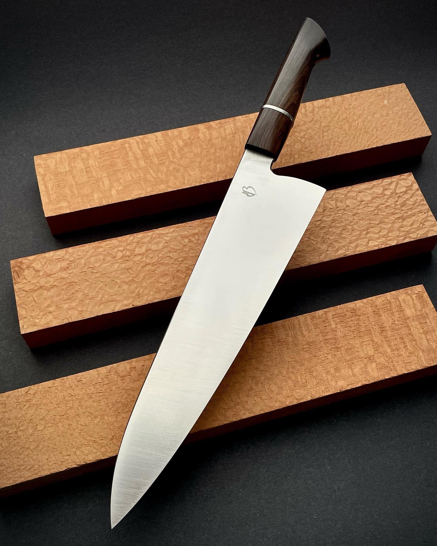 A large 255mm gyuto in 3V steel, 63mm tall at the heel, with a forward balance just in-front of the makers mark. Thin convex grind focused on ease of cutting. The handle is African Blackwood with a textured titanium spacer. (Spoken for)
&bull;
#perfo
