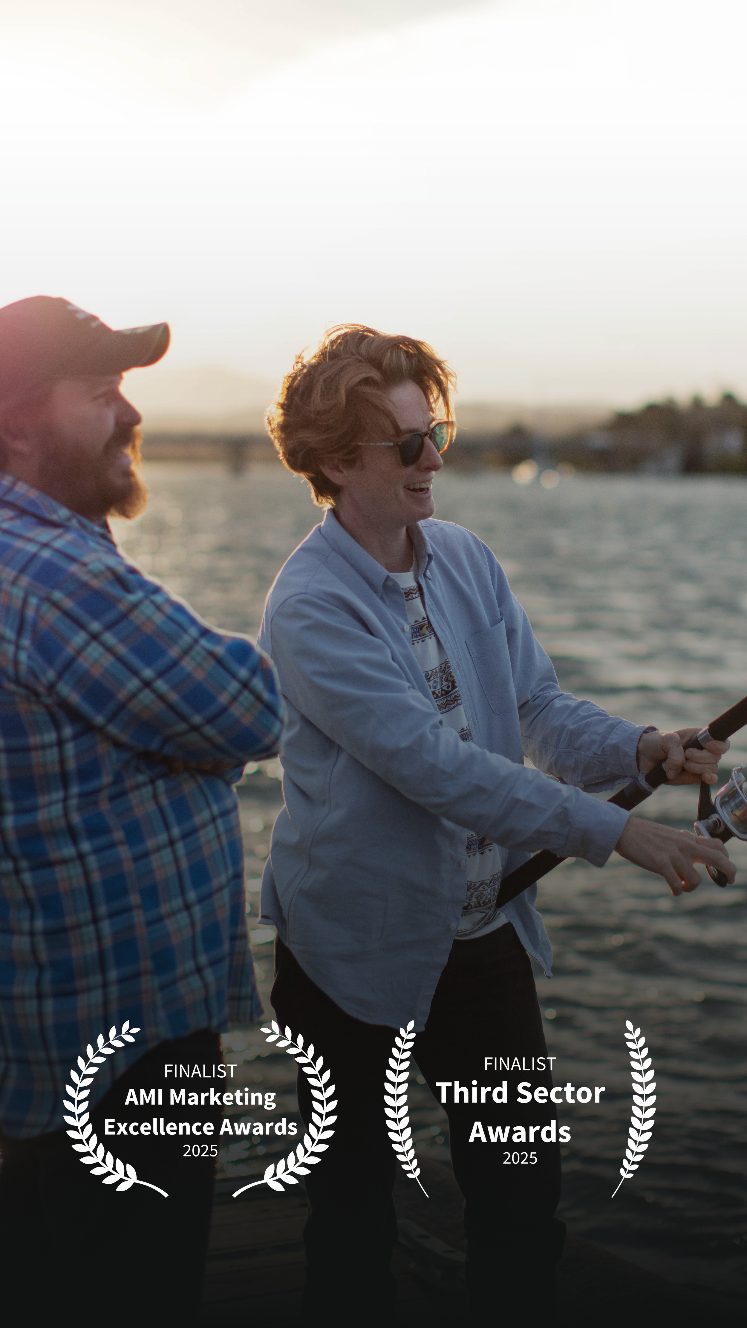 A frame of two Grand Pacific Health workers smiling and fishing as the sun drops. BC Film award reefs are displayed on the image.