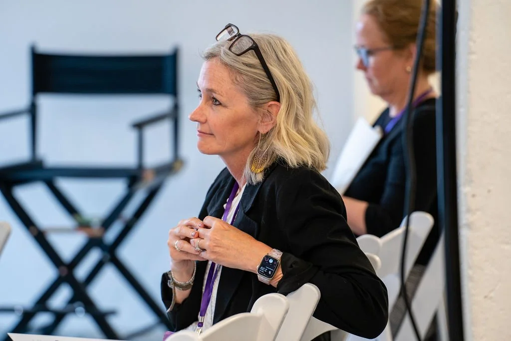 side profile of woman in black blazer