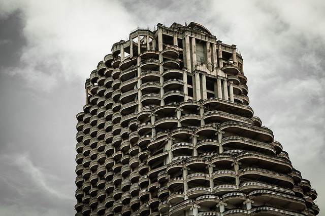 Sathorn Unique Tower also known as The Ghost Tower is an unfinished abandoned skyscraper in Bangkok's Sathon District. The building was built in 1990. It was planned as a 47-storey luxury condominium tower with 600 units but due to the lack of funds and other unfortunate events, including the architect being brought up on murder plotting charges. The Tower stands unfinished to this day. Despite being officially off-limits to the public, the building has become well known as an urban exploration destination. Numerous ghost tales have surfaced over the years with some locals believing the building to be cursed and whoever enters it will also be cursed, as the land upon which it sits is said to be a former graveyard. In December 2014, the body of a Swedish man was found hanged on the 43rd floor. The cause of death was determined as suicide. The building is still popular with international tourists but criminal charges of trespassing will be given to those attempting to enter. This is due to safety issues. The building is now used as a giant advertising billboard.