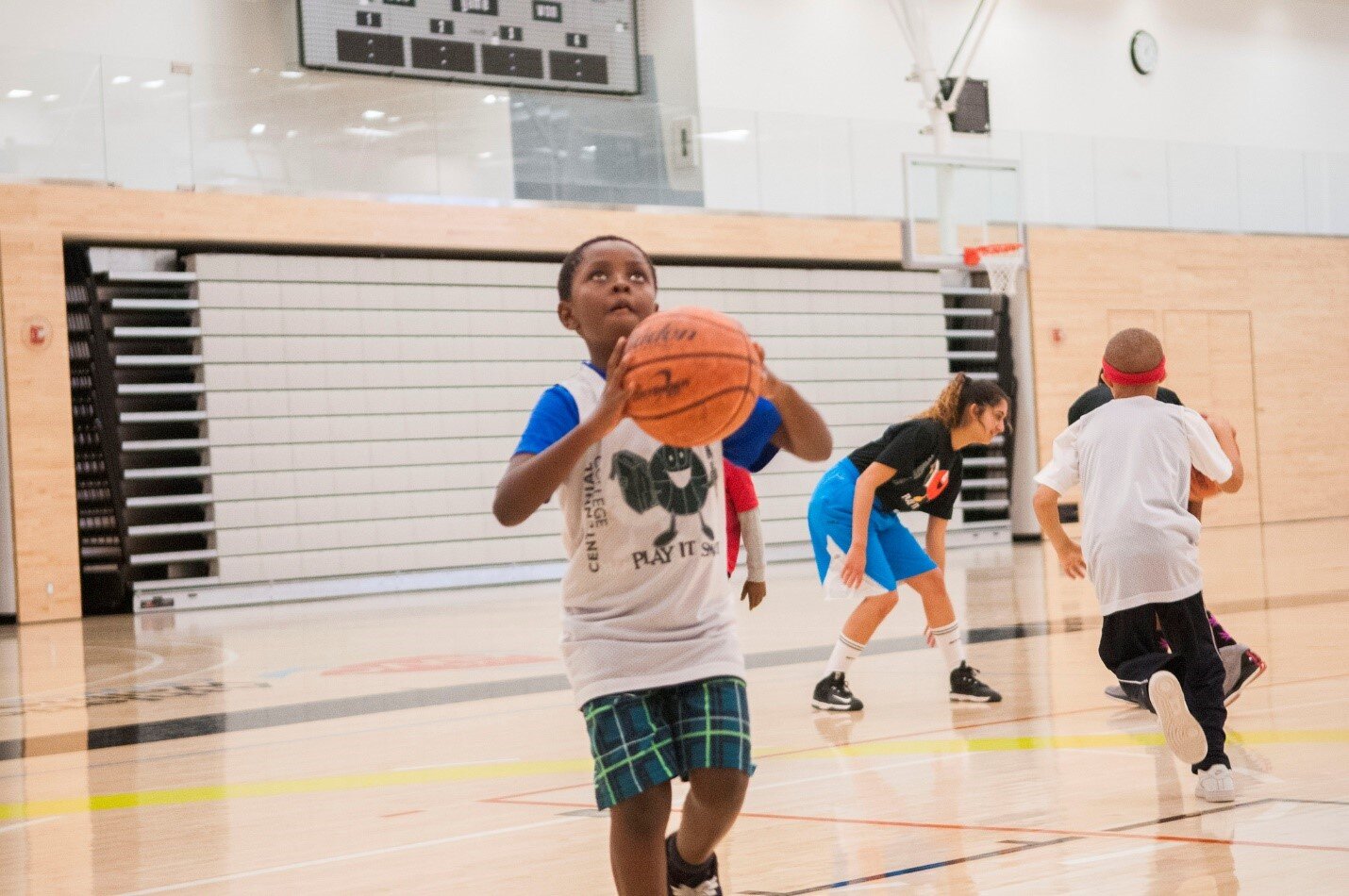 Black boy shooting a basketball