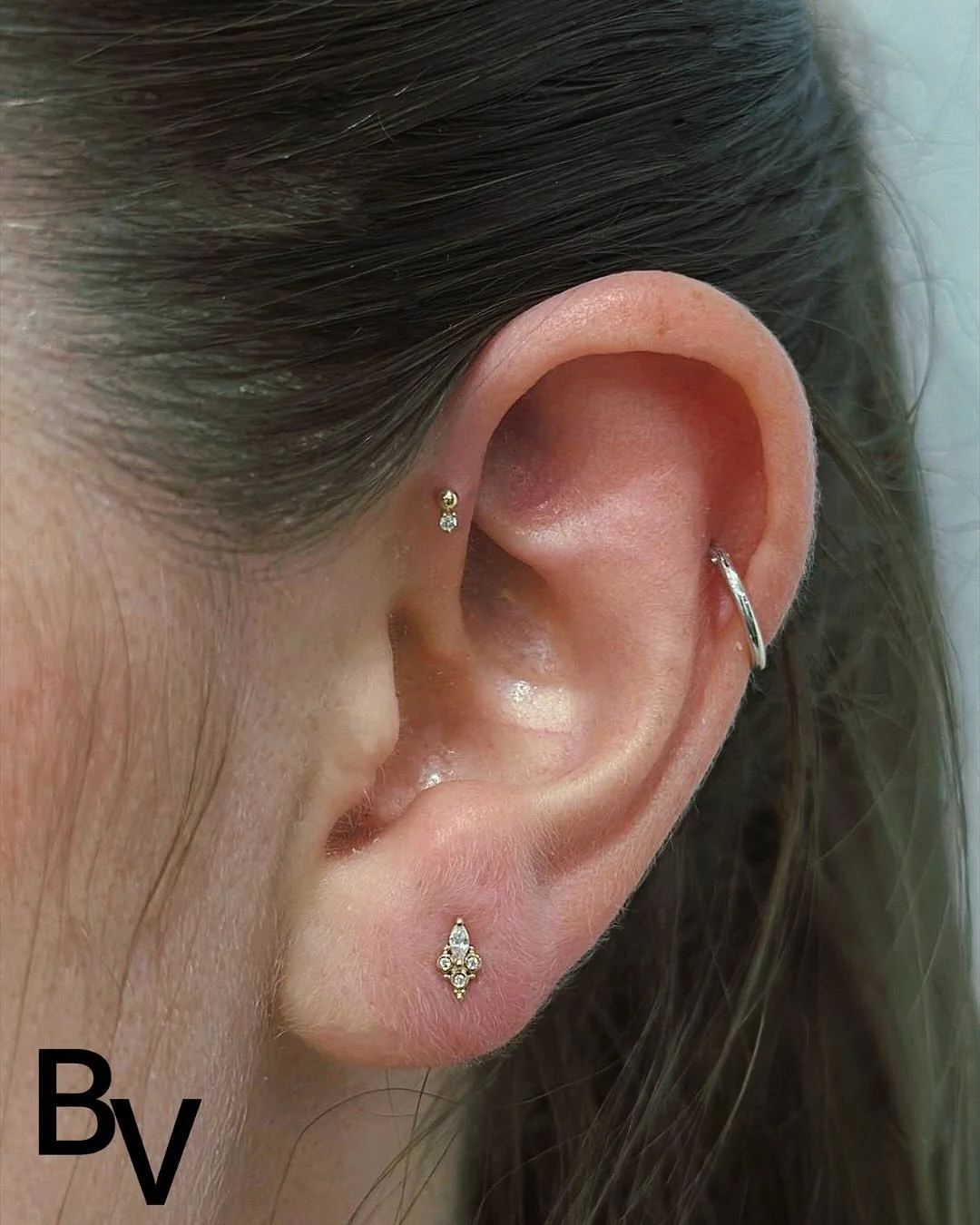 ✨ Elevate your ear game with &lsquo;Mai&rsquo;. This exquisite 14k gold pieces# is adorned with a brilliant Swarovski, and is the perfect blend of elegance and edge. 💎✨ Every client wearing this beauty is shining brighter than ever, showcasing a uni