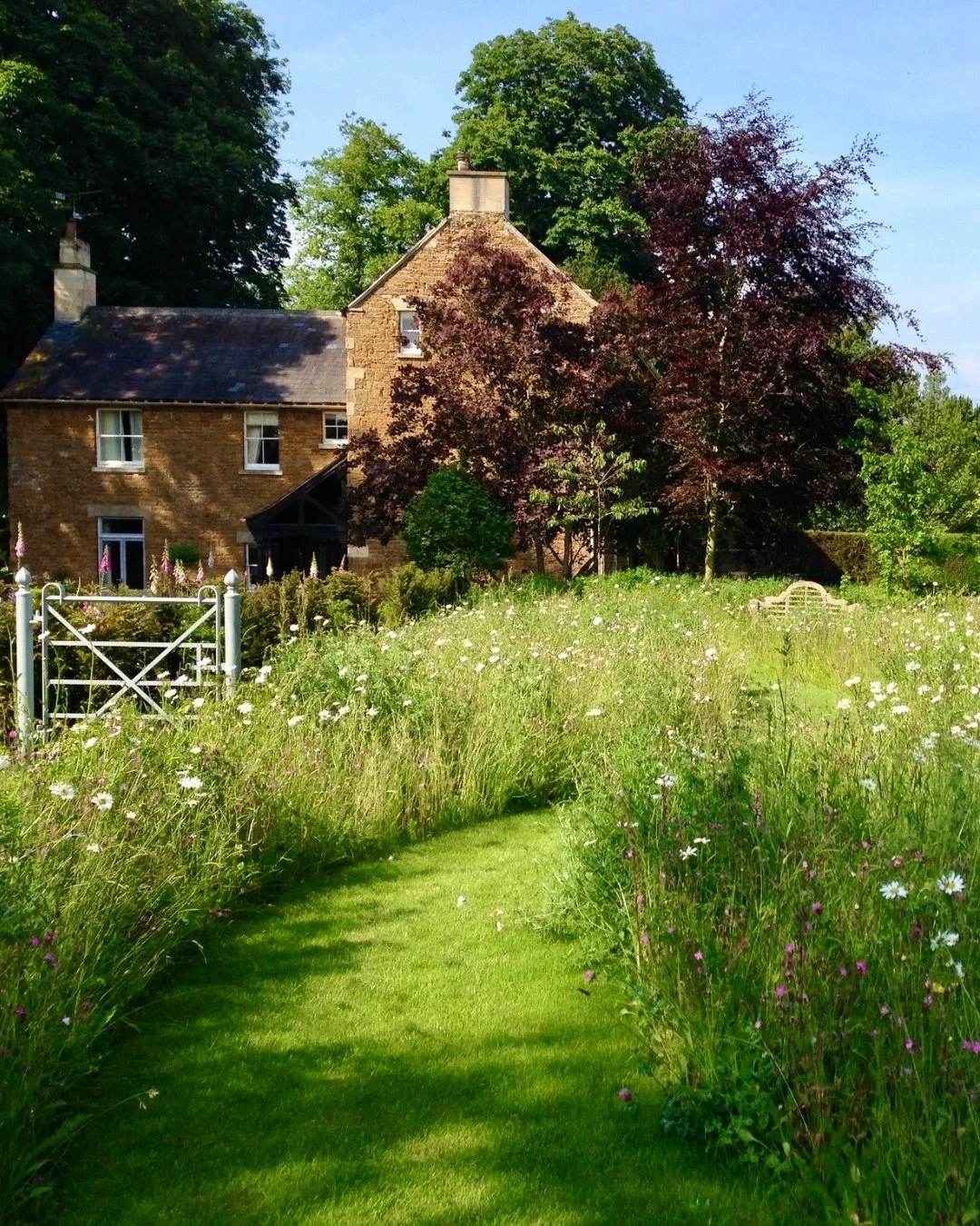 I&rsquo;ve always loved the contrast between something wild and something ordered. In this English countryside garden the wild meadow brings a sense of freedom and movement, not to mention a huge benefit to wildlife, while the water feature, paving a