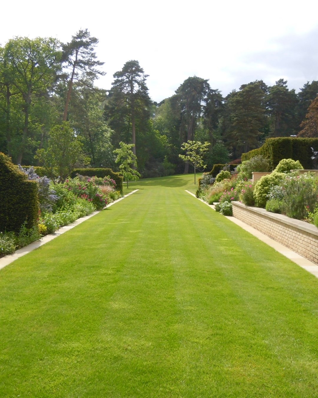 When I&rsquo;m lucky enough to work with a larger garden, I always start by thinking about how people will move through the space. This long lawn became the backbone of the design; a simple gesture that stretches the eye and creates that unmistakable