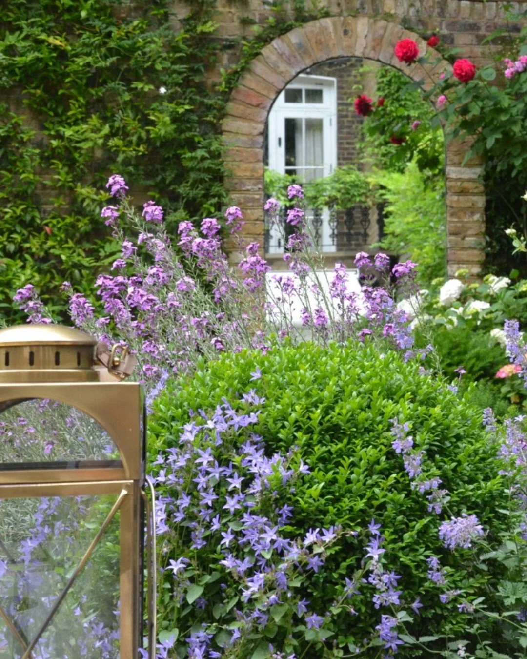 The mirror in the corner of this garden is a great way to make a smaller space feel bigger. It's one of my favourite tricks to add depth, reflect light and create the feeling that the garden carries on beyond its boundaries.

Designing urban gardens 
