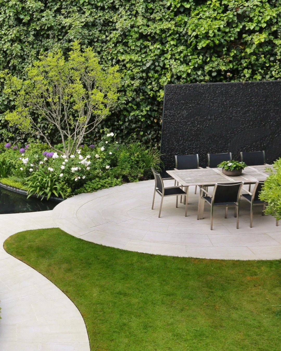One of the things I always think about when designing a garden is sound. We tend to focus on what a garden looks like, but what we hear can be just as important to the way a space feels. For this garden design, I included a black granite water wall b