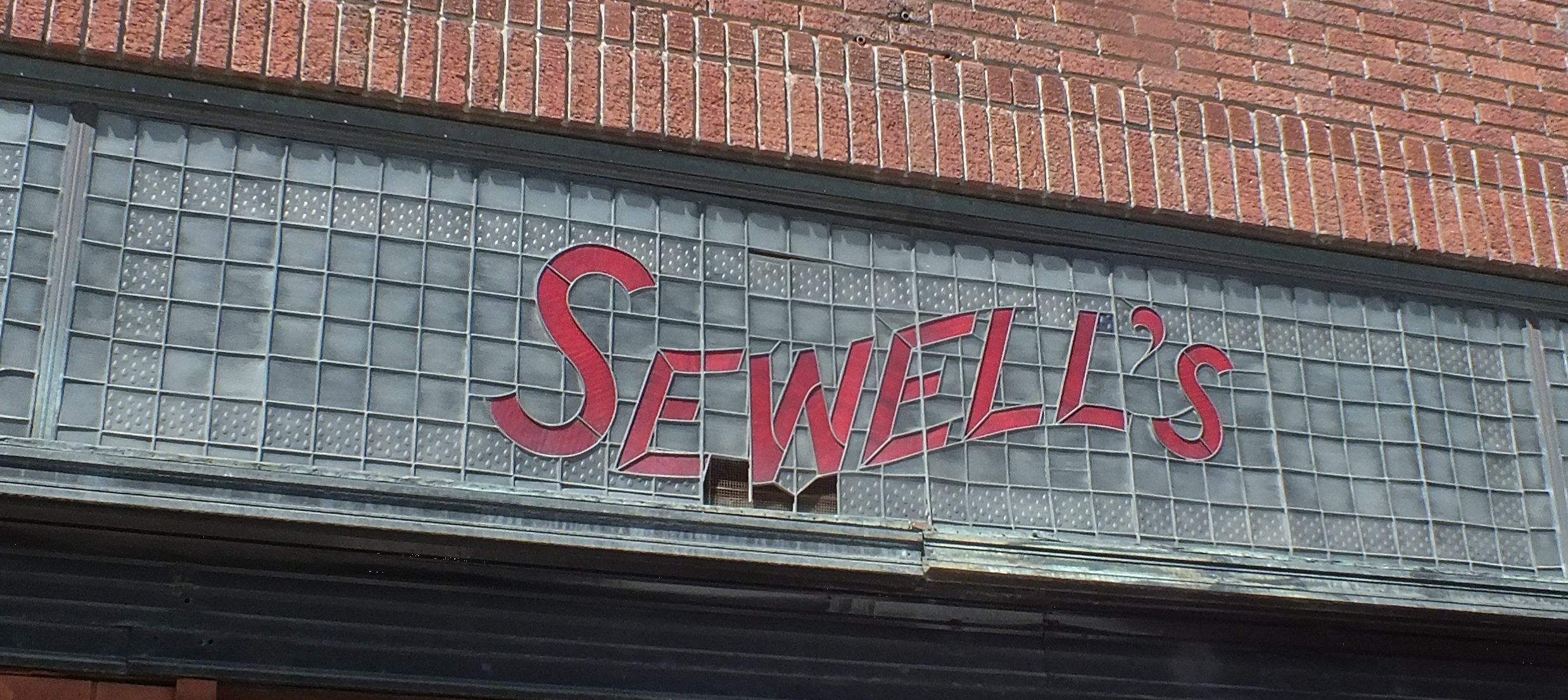The Sewell’s sign at 221 East Park Ave before being removed for restoration.