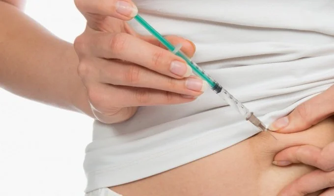 women injecting weight loss medication semaglutide