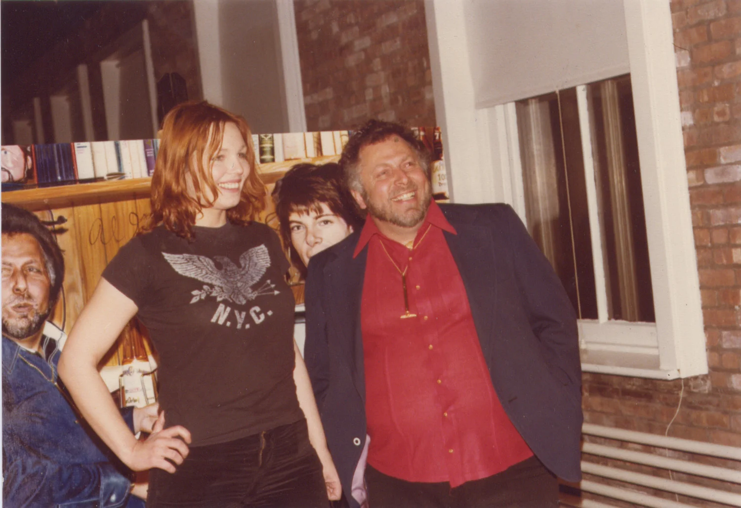 An audience member poses for a polaroid with Al Goldstein