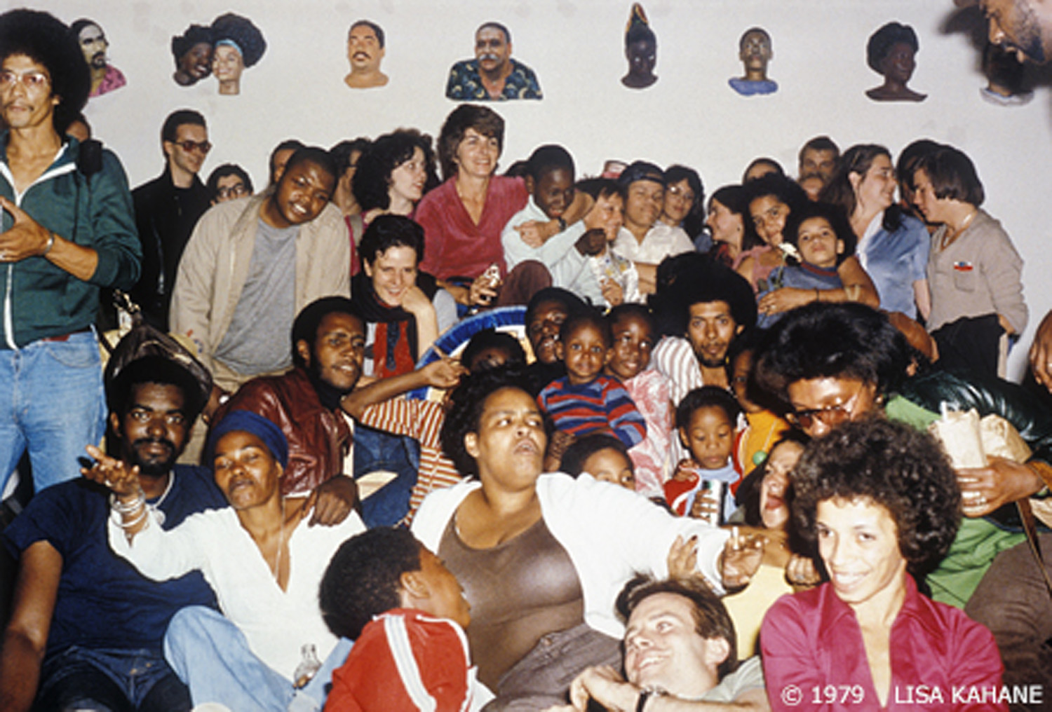 Closing of John Ahearn exhibition at Fashion/Moda in the South Bronx. Sculptor Ahearn (bottom center) with friends and subjects of his casts, 1979. Photo by Lisa Kahane