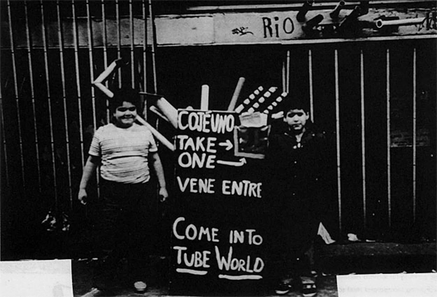 Local children Maria Acosta and friend stand by the Tube World signboard in front of No Rio, 1982. Photo by Jody Culkin