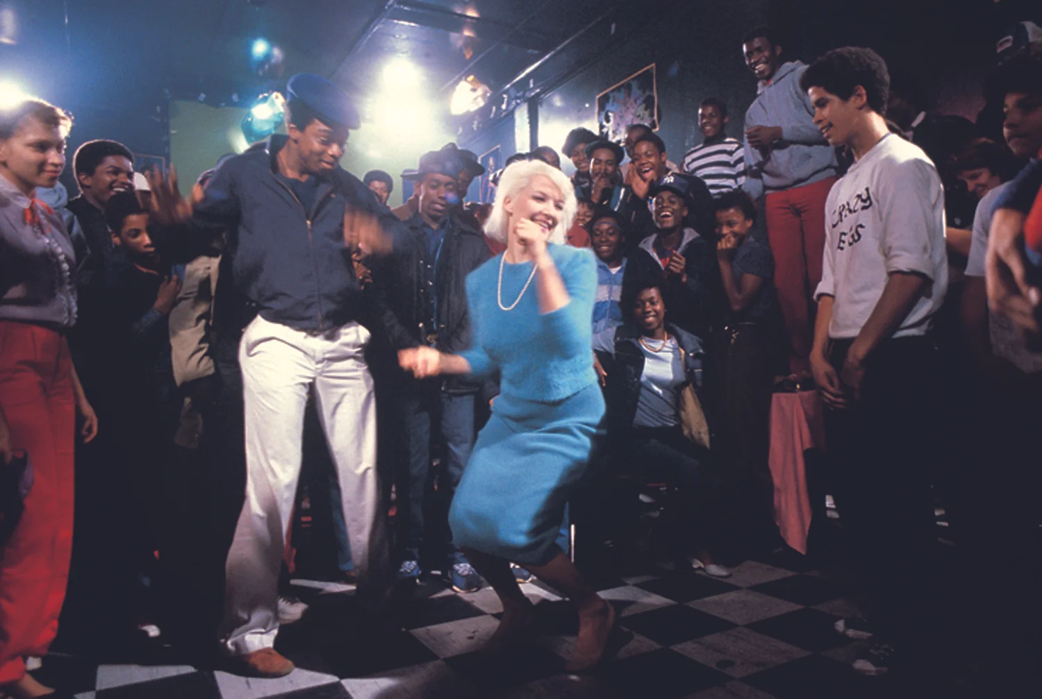 Patti Astor hunkers down in this scene from Charlie Ahearn's 1982 Wild Style (First Run Features), a film about the rap and graffiti scene in the South Bronx. Astor was a co-director of the Fun Gallery on East 10th Street. Photo by Martha Cooper