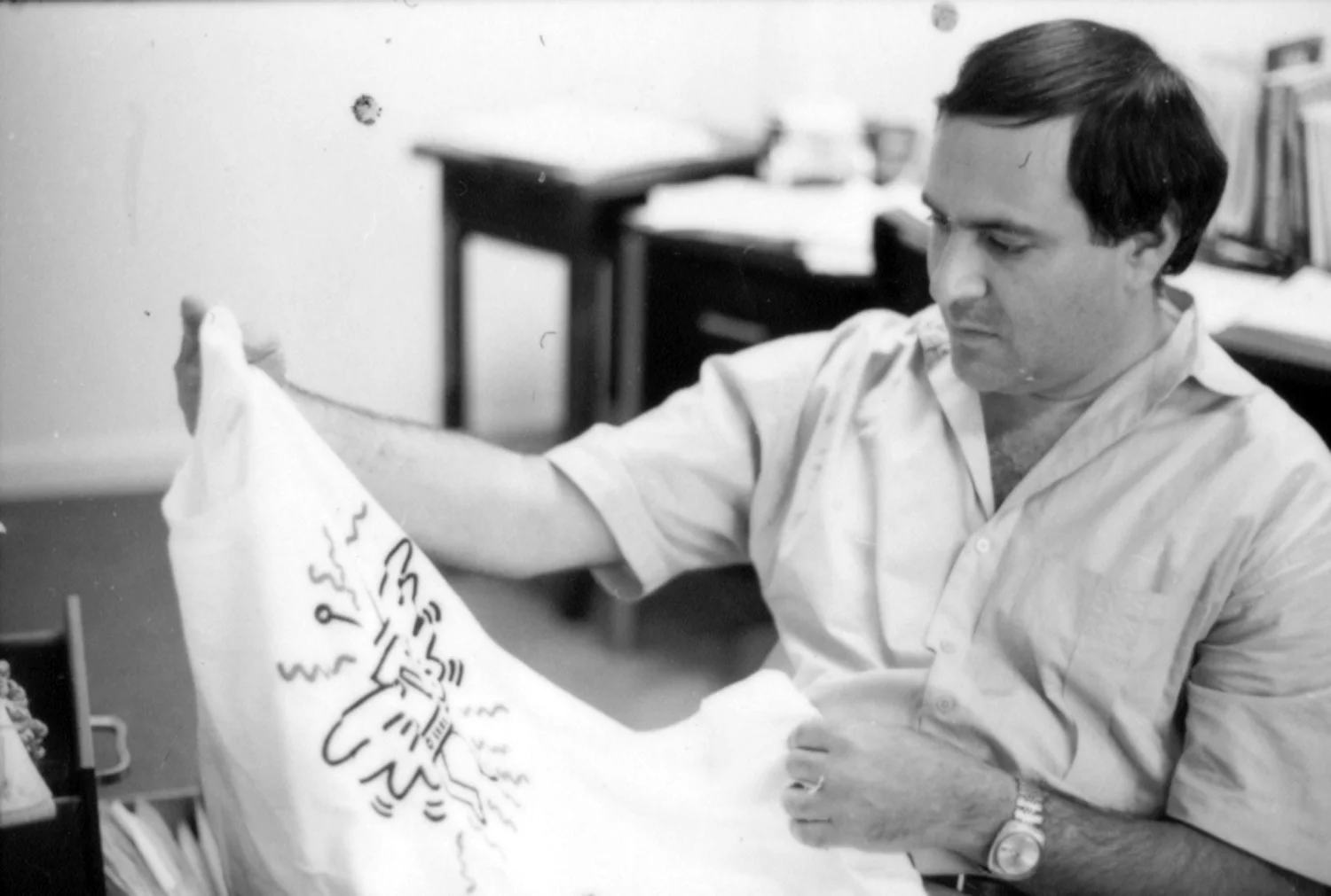 Examining a Keith Haring T-shirt for the exhibition Television's Impact on Contemporary Art, c. 1986
