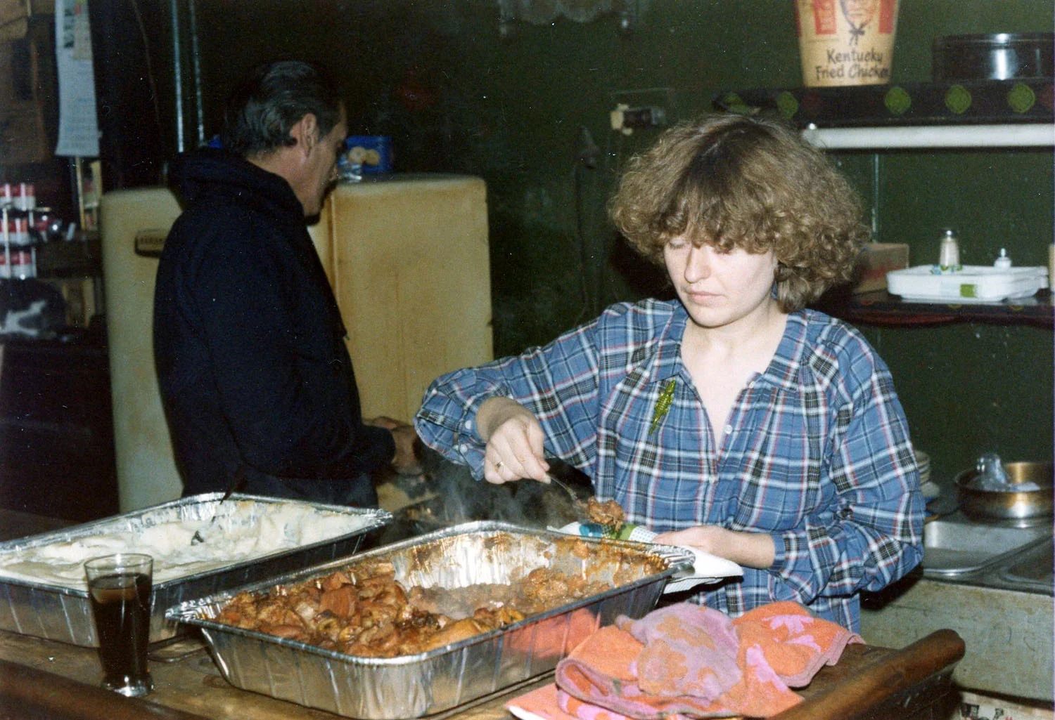 Becky serves up the mashed potatoes and stuffing in the kitchen area of the bar.