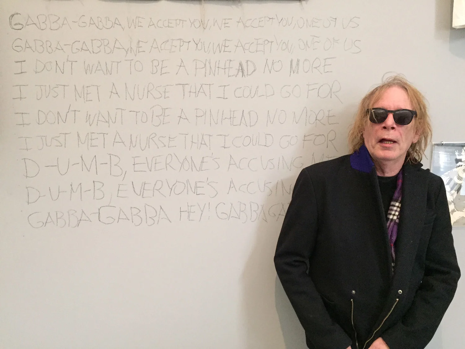 Punk magazine co-founder and "resident punk" Legs McNeil with the lyrics to the Ramones' song "Pinhead," which he scrawled onto the wall of the Queens Museum. Photo by Pema Domingo-Barker.