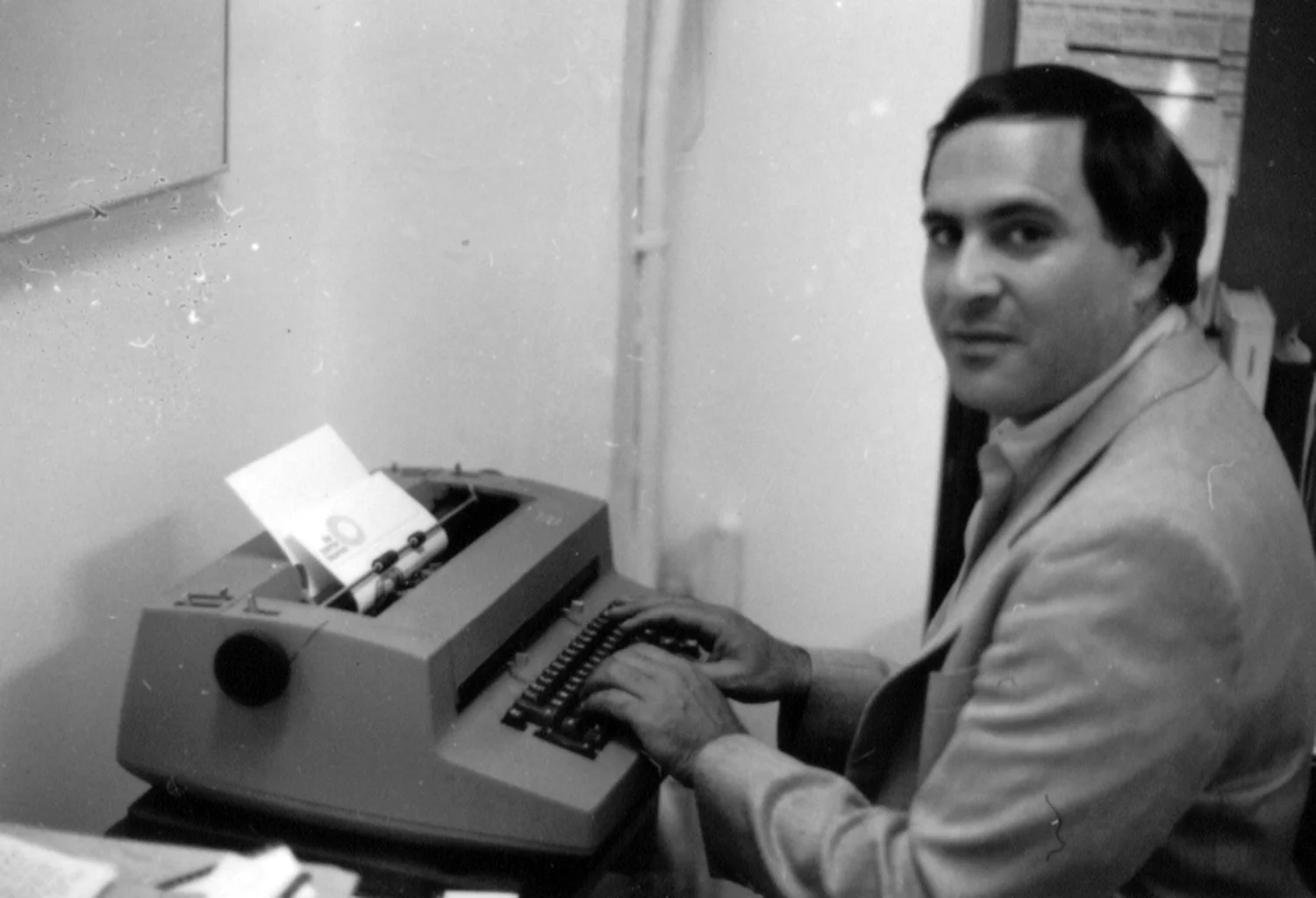 Marc Miller at his IBM Selectric typewriter in his office at the Queens Museum, c. 1986