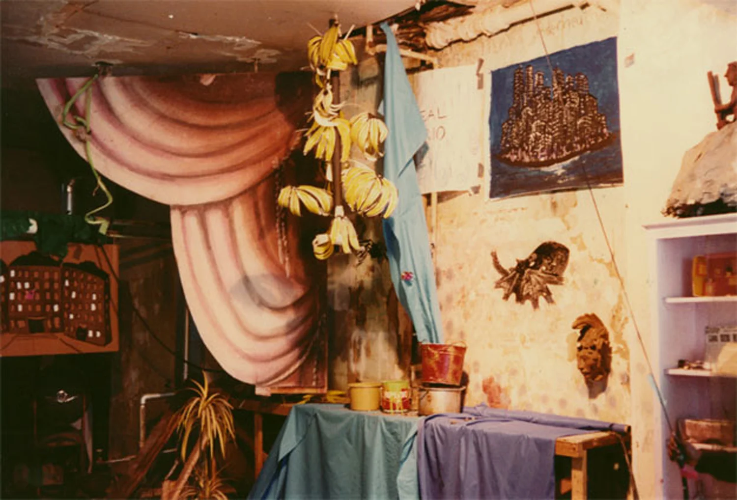 Installation view shows (from left to right) cardboard housing projects by Bobby G; painted curtains, a street find; paper bananas; No Rio's plumbing leak in its early stages; Jane Dickson's Manhattan Island , paint on paper; Becky Howland's Octopus Ink Shadow , ink on vellum; and different found sculptures. Photo by Becky Howland