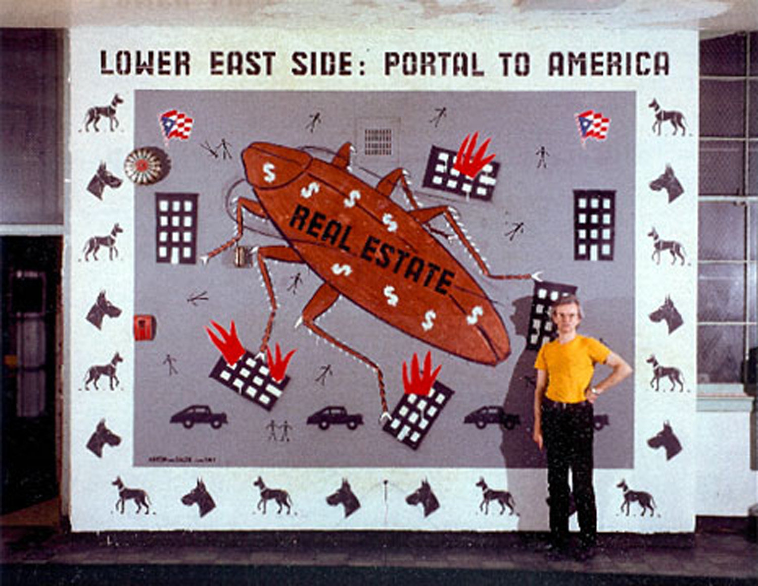 Anton Van Dalen stands in front of his mural painted for the 1980 9th Street Survivial Show in the CHARAS-run ex-public school, now a community center called El Bohio. The mural remained in place until 1983 Not For Sale exhibition at El Bohio.