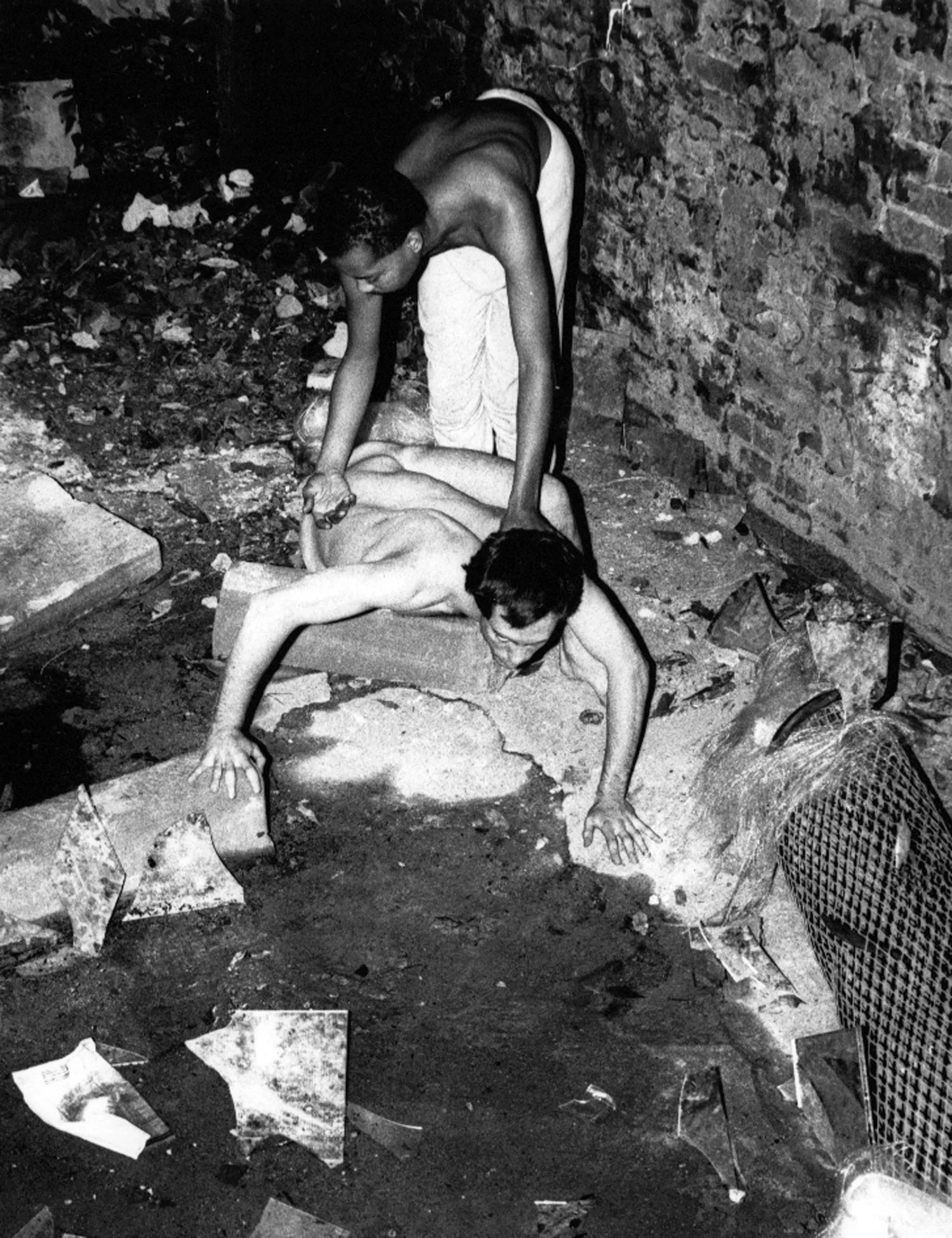 Jack Waters and Peter Francis performing in the back yard at dawn, using found materials like broken glass, sticks, and mirrors sprinkled with copy fluids. Photo by Toyo