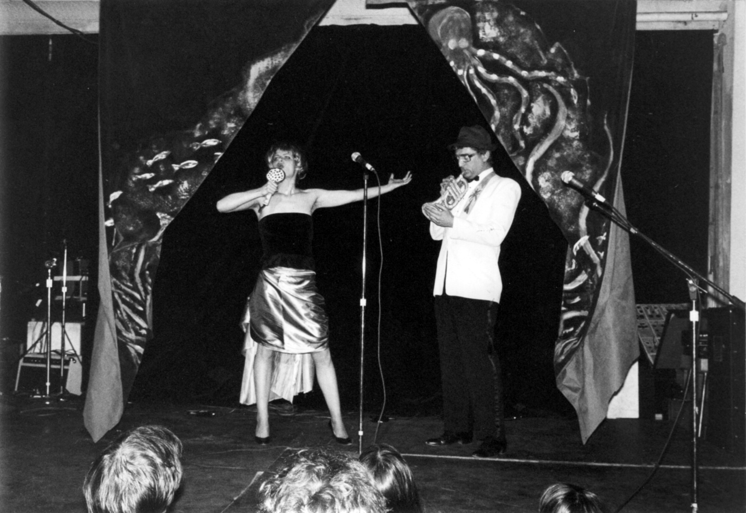 No Rio's Cardboad Air Band at the Island of Negative Utopia: Bebe Smith belts out a song as Walter Robinson "plays" trumpet. Photo by Teri Slotkin