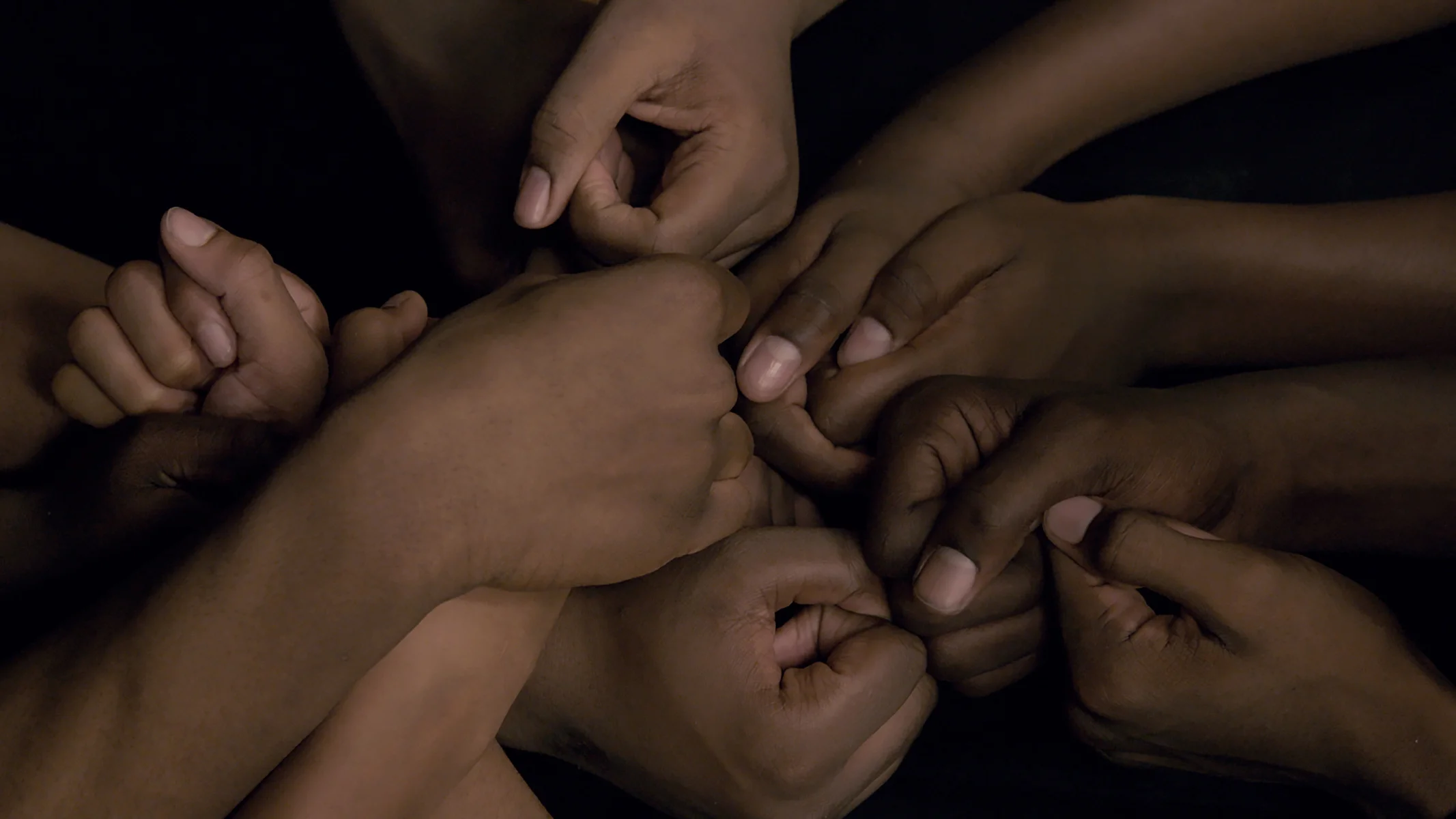 12_WRESTLE_The team puts their hands together at the end of each practice.jpg