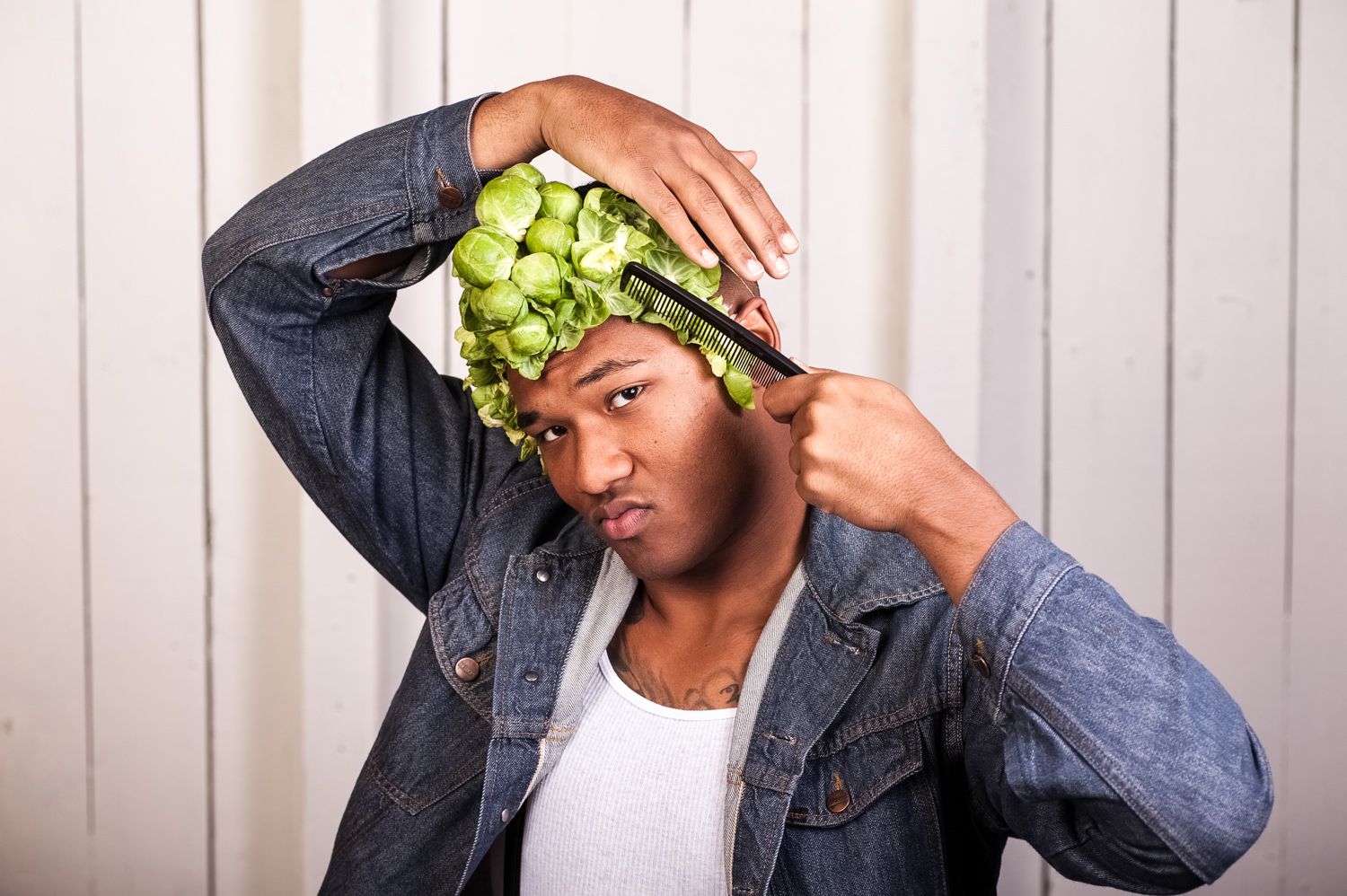 man combing fake hair with brussel sprouts