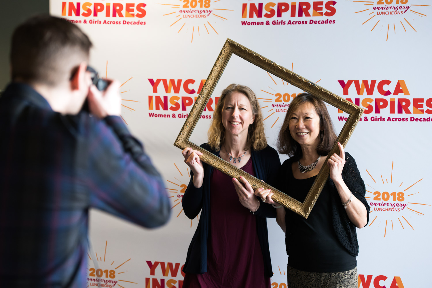 women posing at step and repeat