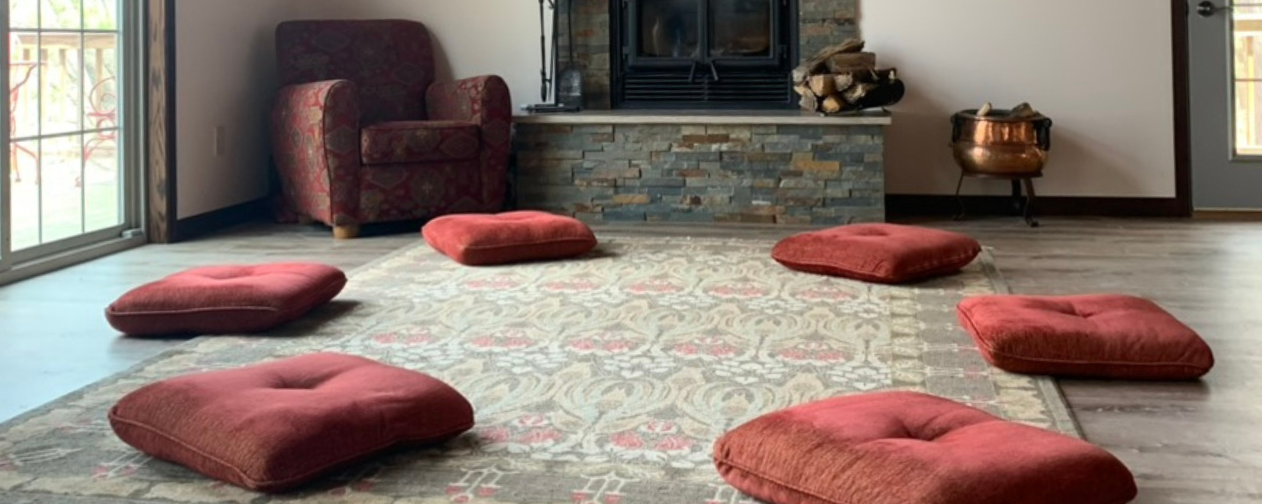 An image of six cusions on the circle of the floor of the practice's retreat space in Wisconsin