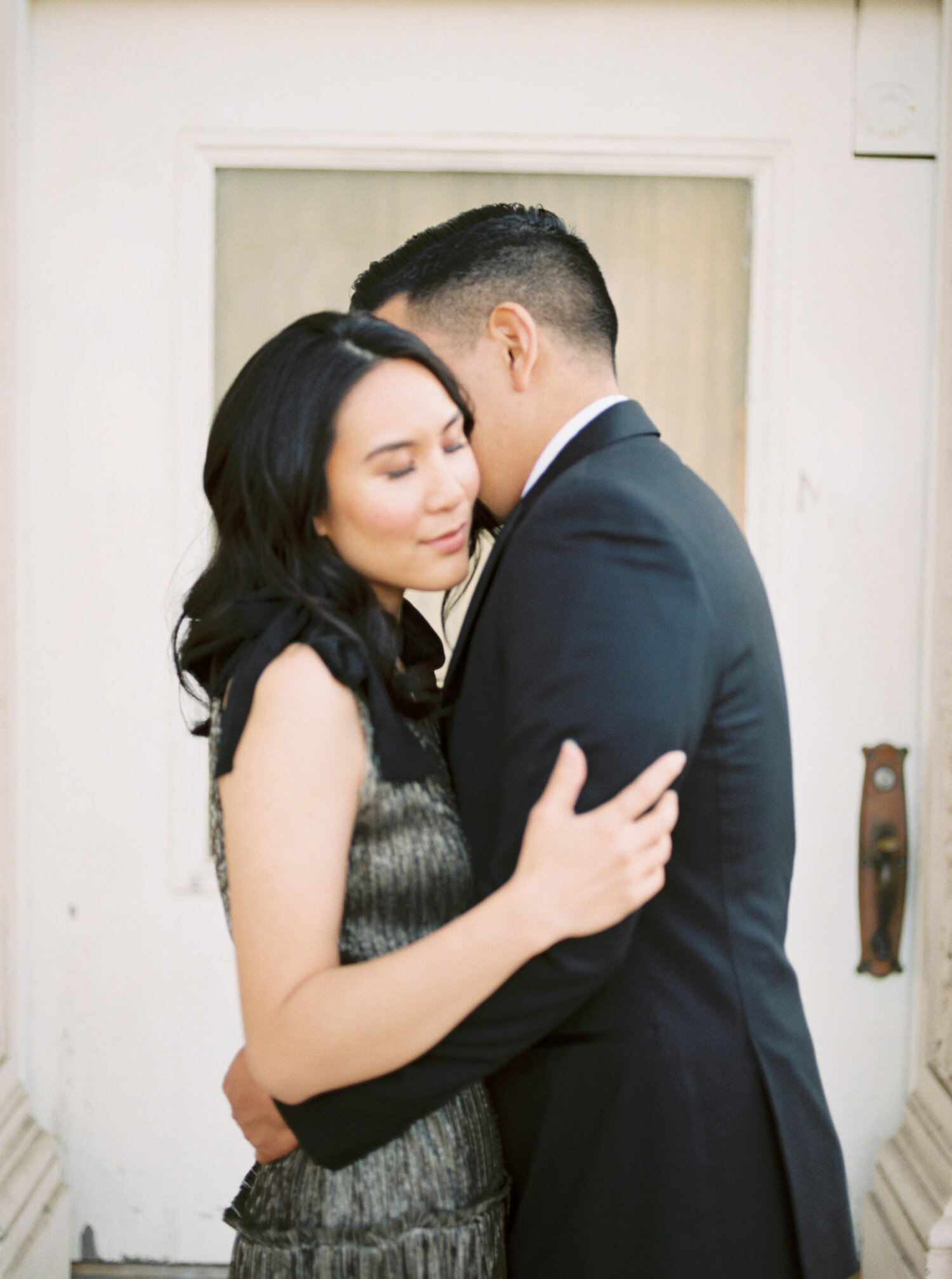 Engagement session on film with stylish gold and black Revolve dress and black suit at Balboa Park in San Diego by Liz Andolina Photography