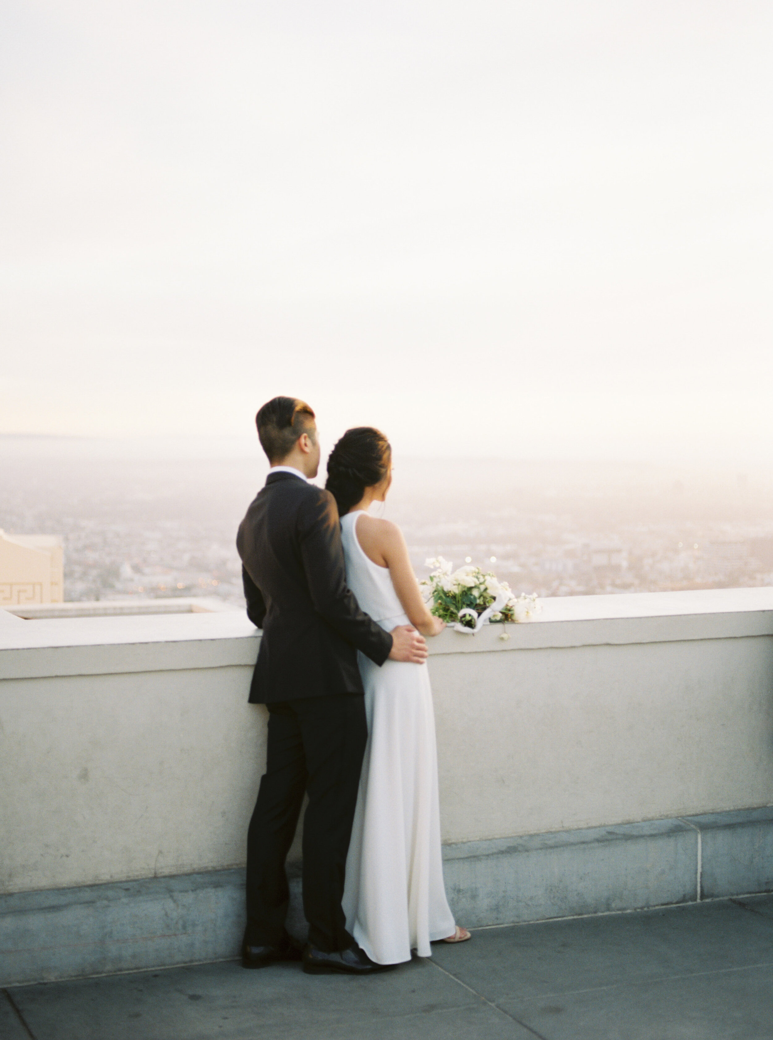 Elegant and romantic old Hollywood wedding with beaded Naeem Khan wedding gown, white organic florals, and epic sunset views at Griffith Observatory in Los Angeles by Liz Andolina Photography