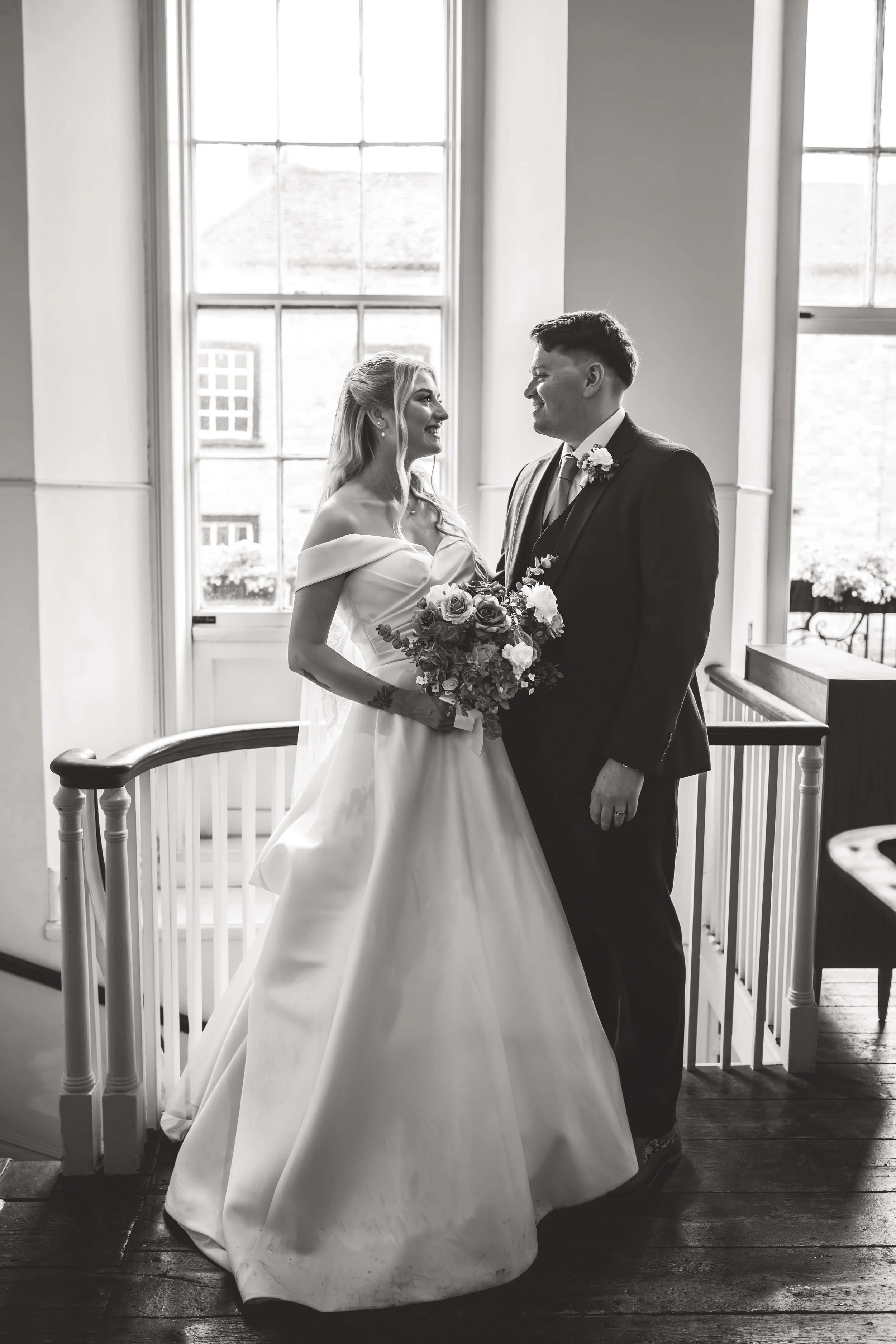 editorial black and white photograph of bride and groom in the ceremonial room 