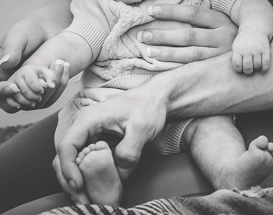 close up of baby hand and little foot 