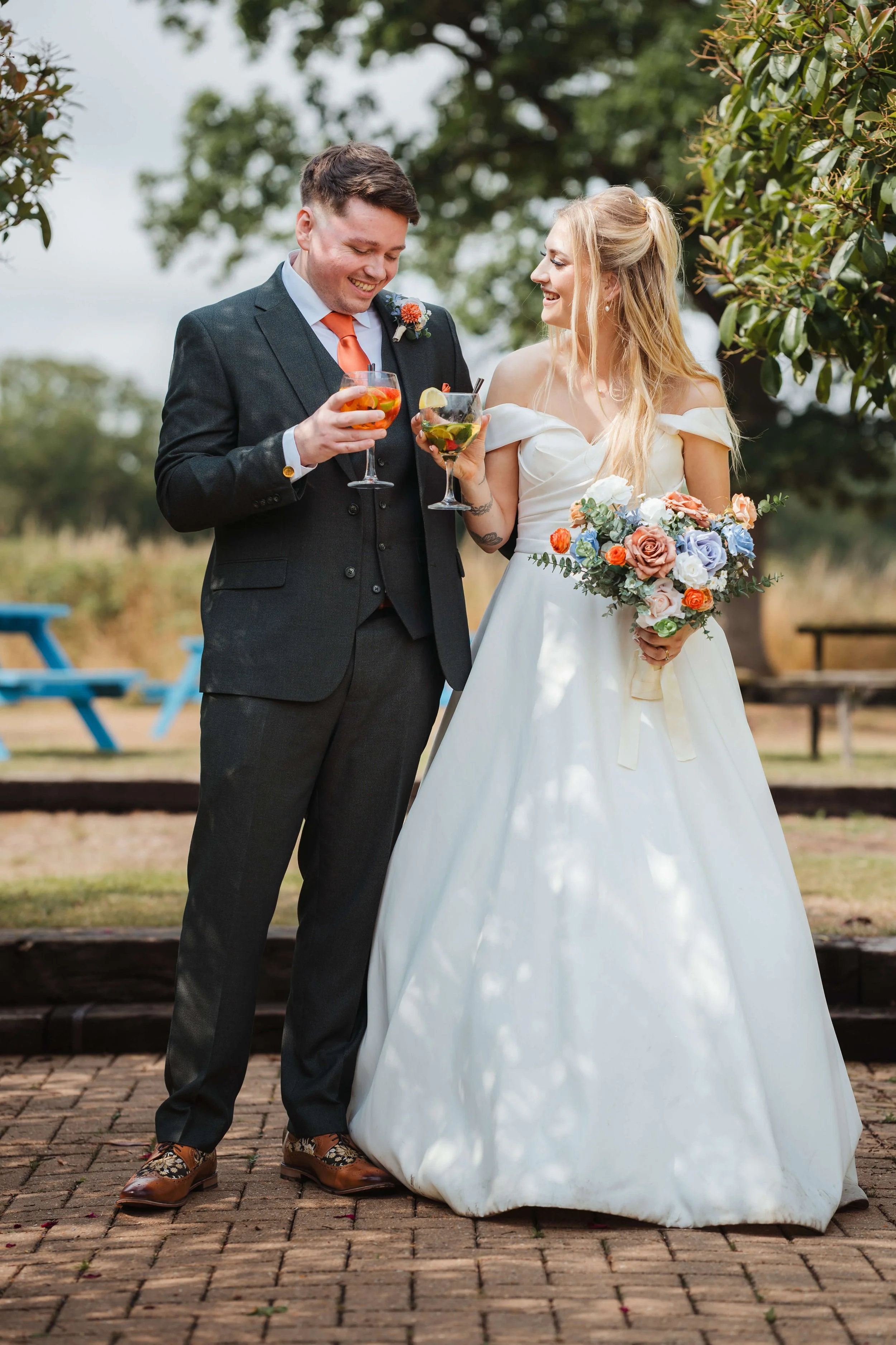 bride and groom clinking glasses containing their favourite drinks 
