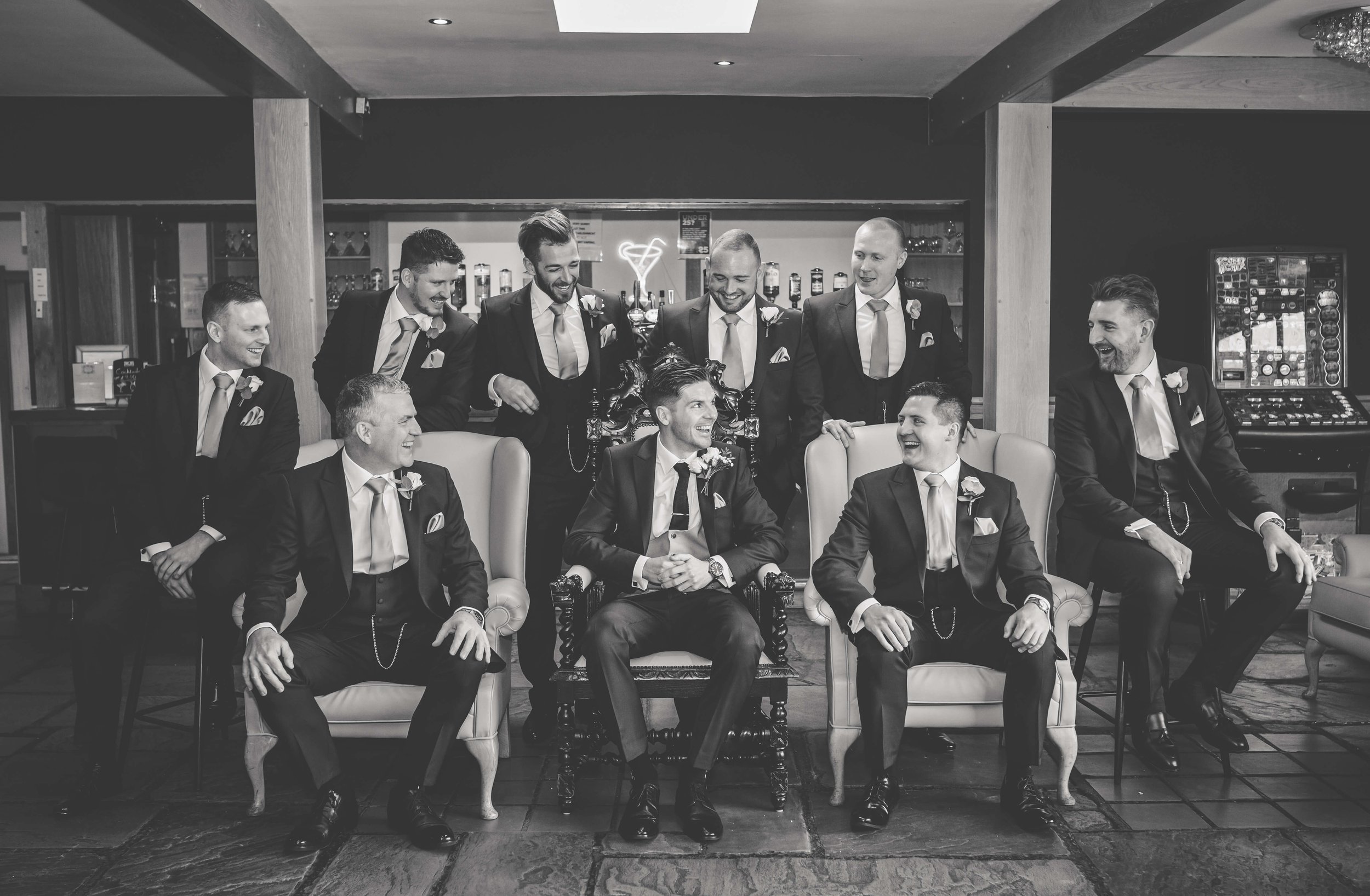 grooms sitting together in and editorial pose