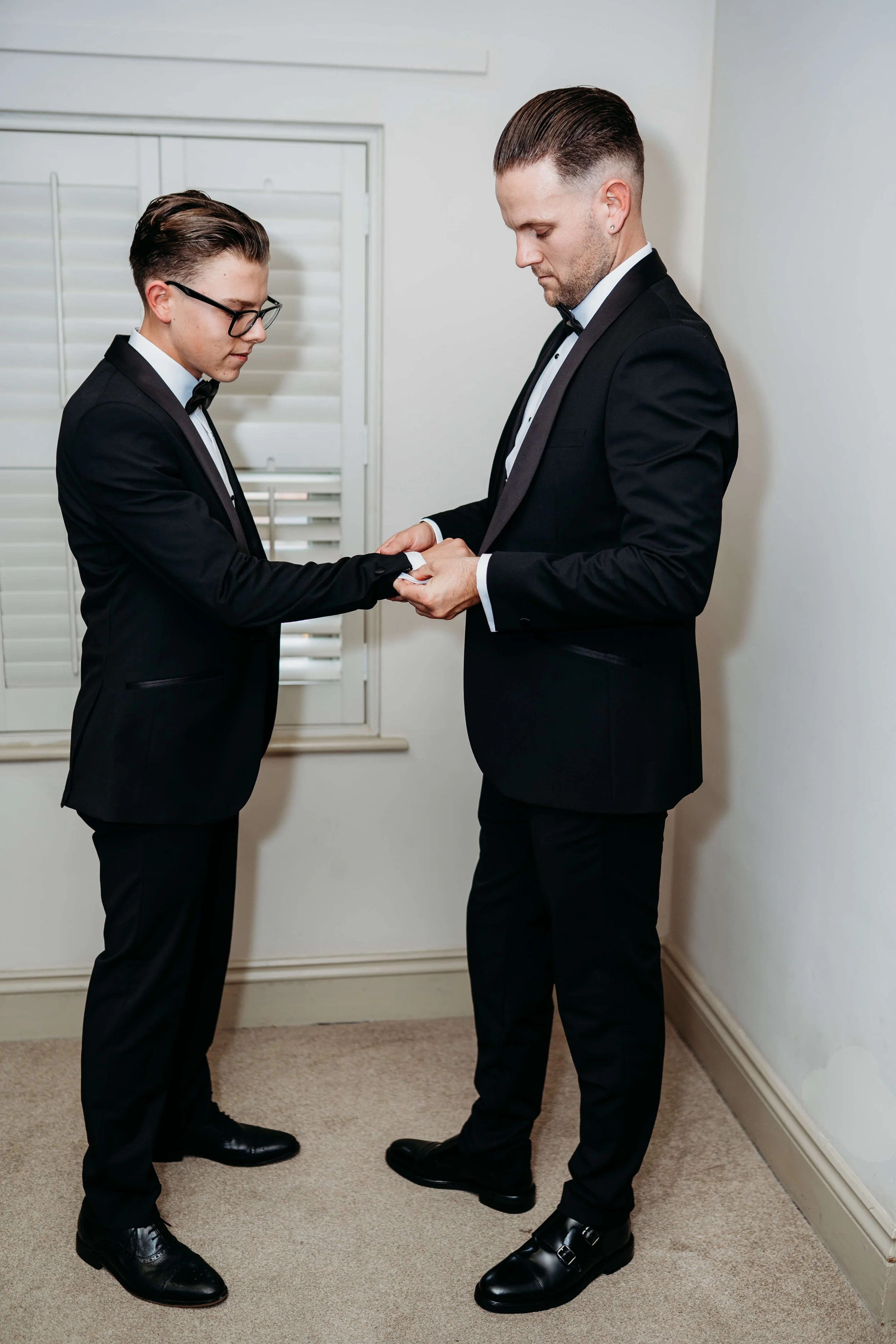 groom helping with sons cufflinks 