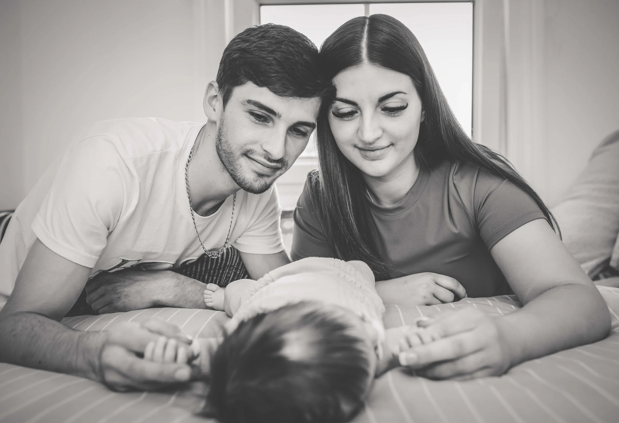 mum and dad at home with their baby 