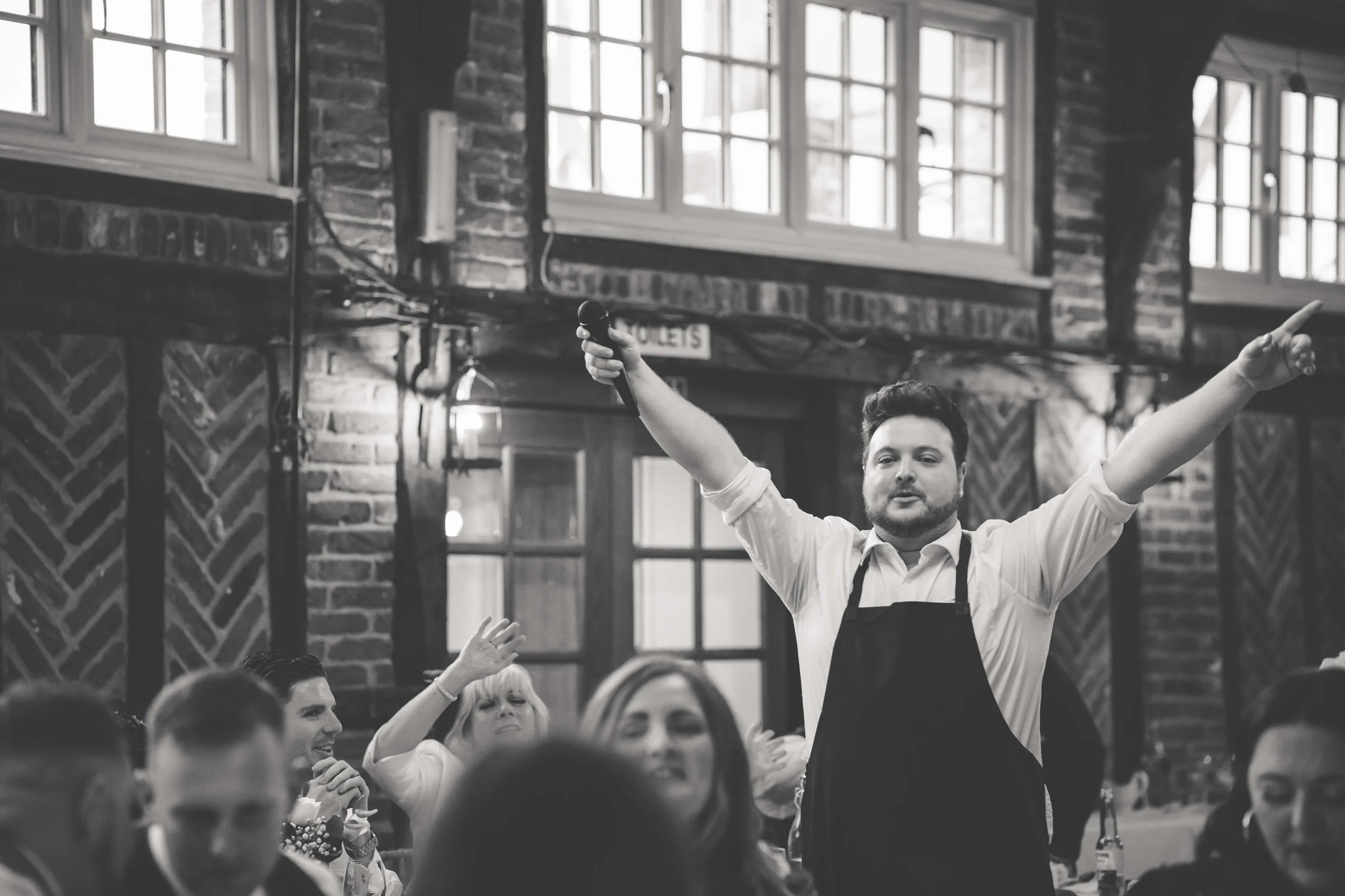 singing waiter entertaining guests at wedding reception
