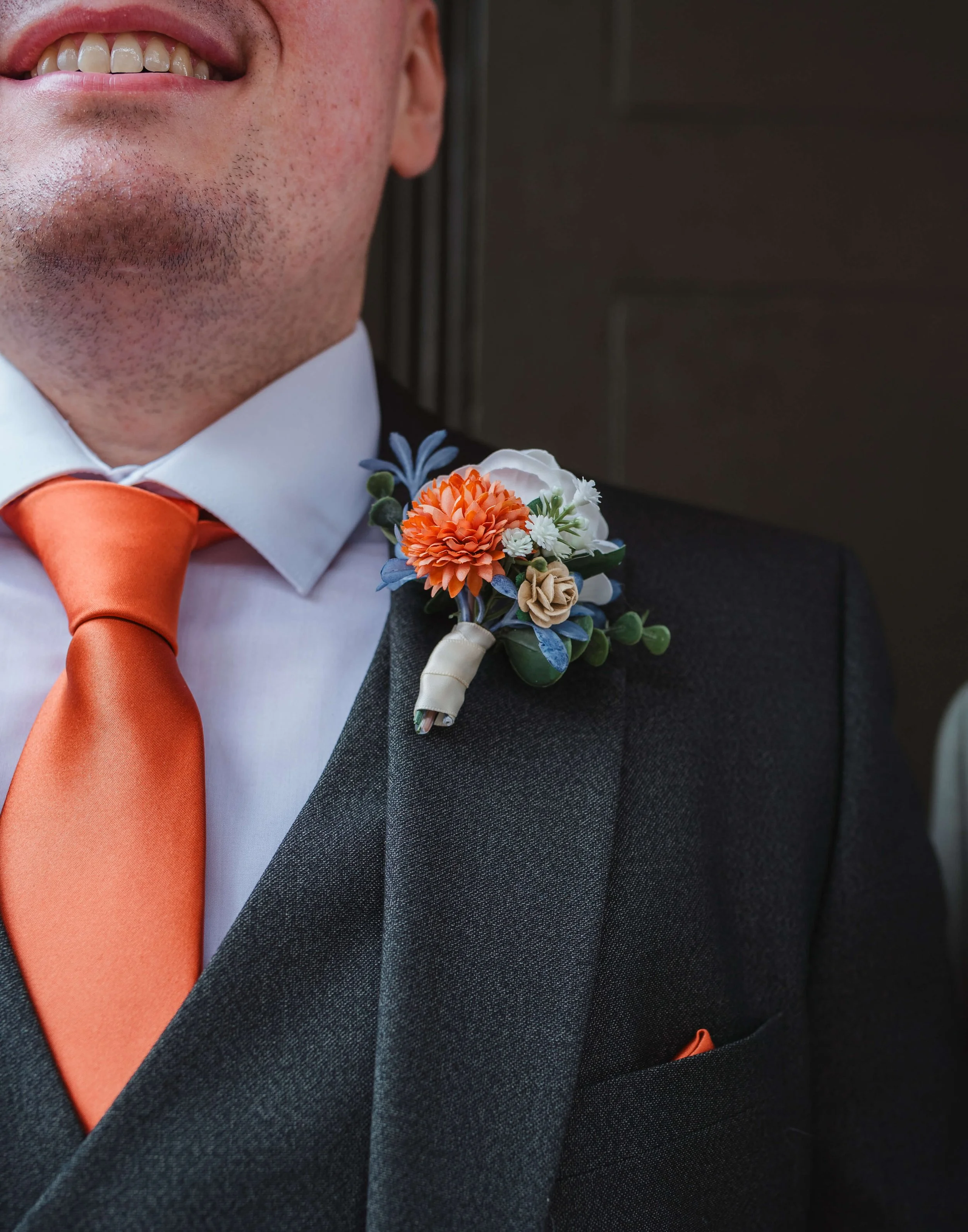 grooms tie and boutonnière close up detail shot 