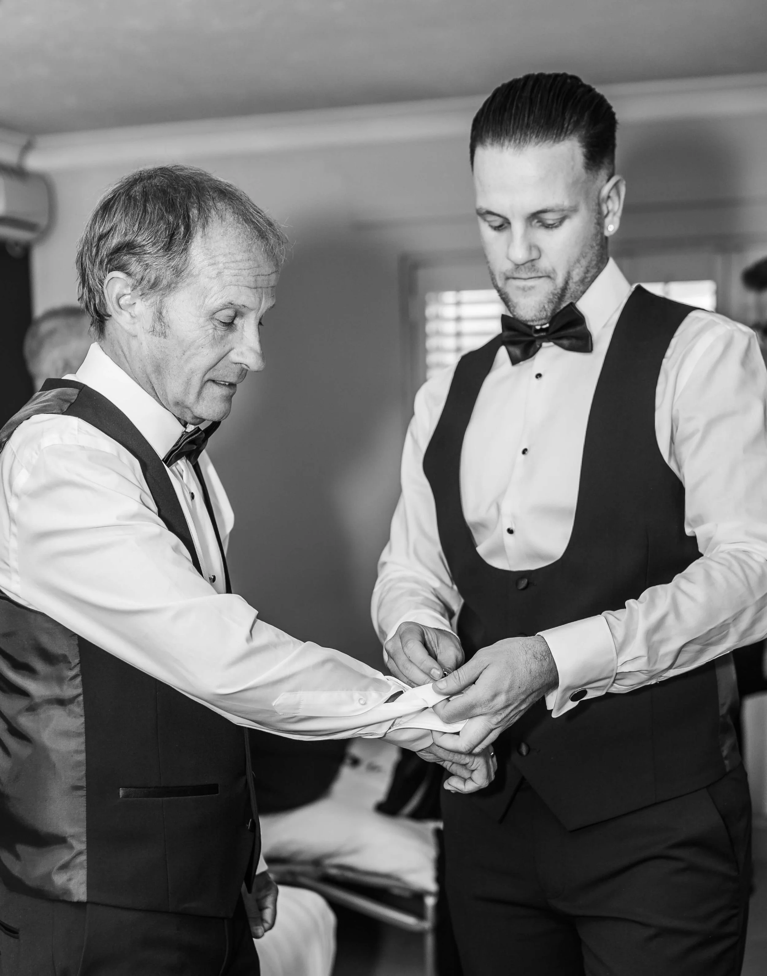 groom helping with dads cufflink