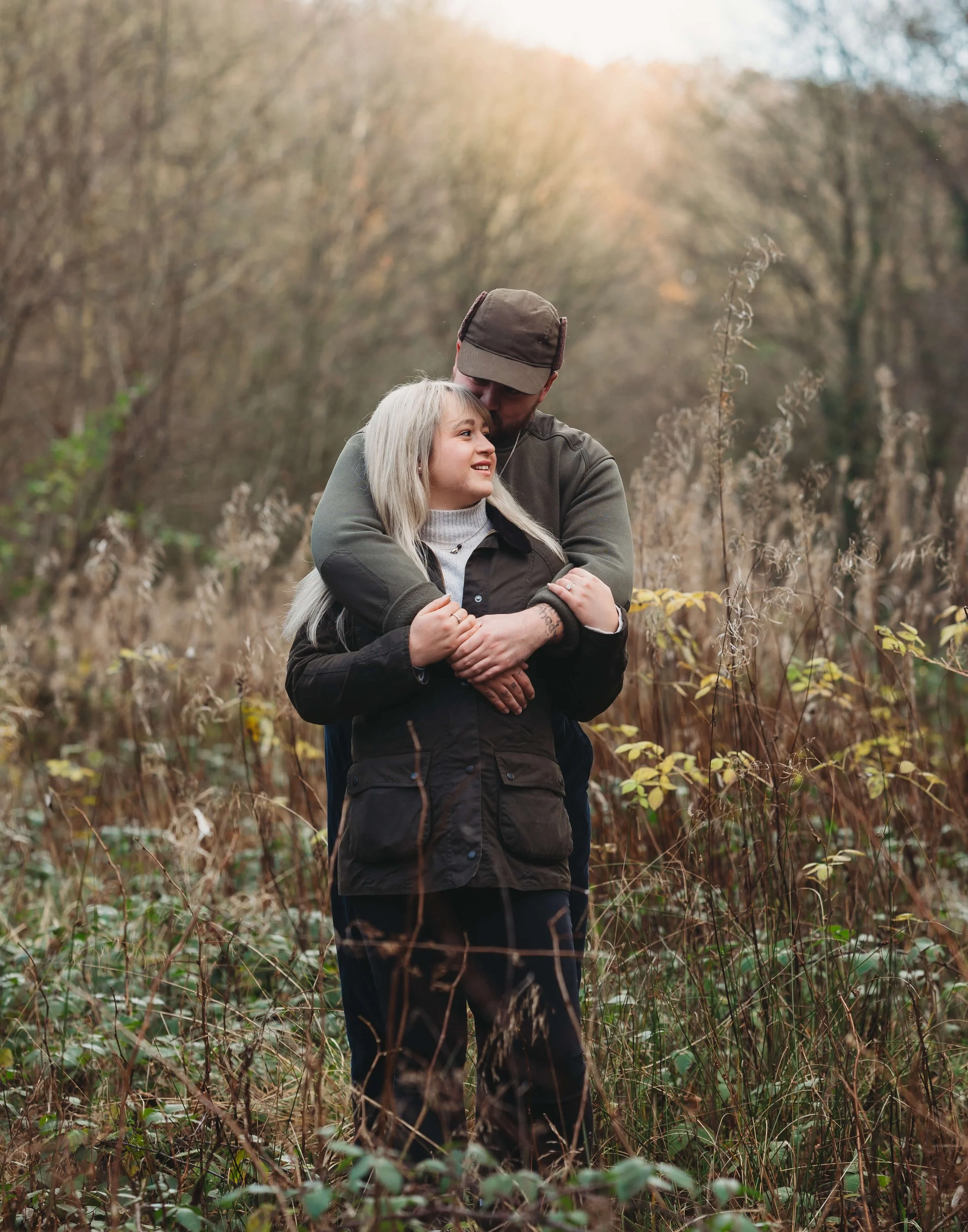 couple having a cuddle in the woods