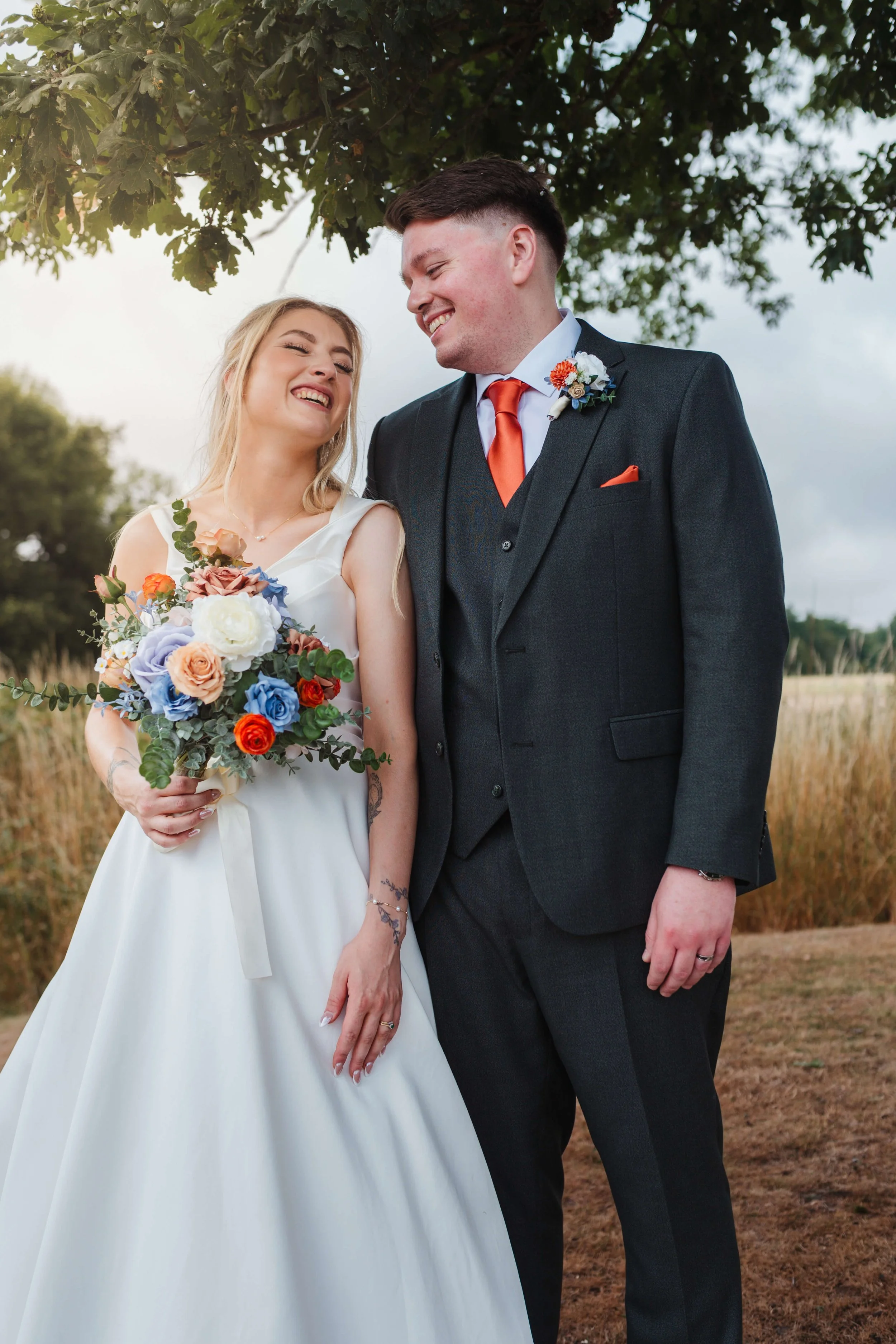 bride and groom sharing a joke 